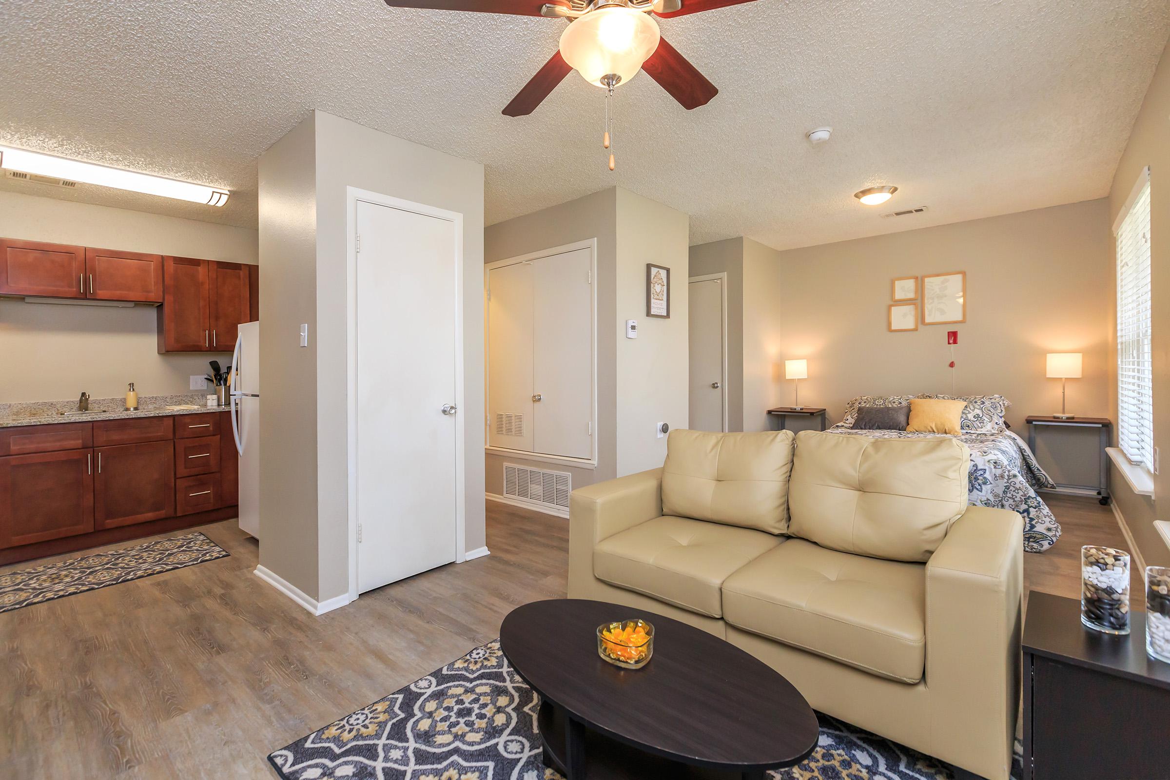 a living room filled with furniture and a flat screen tv