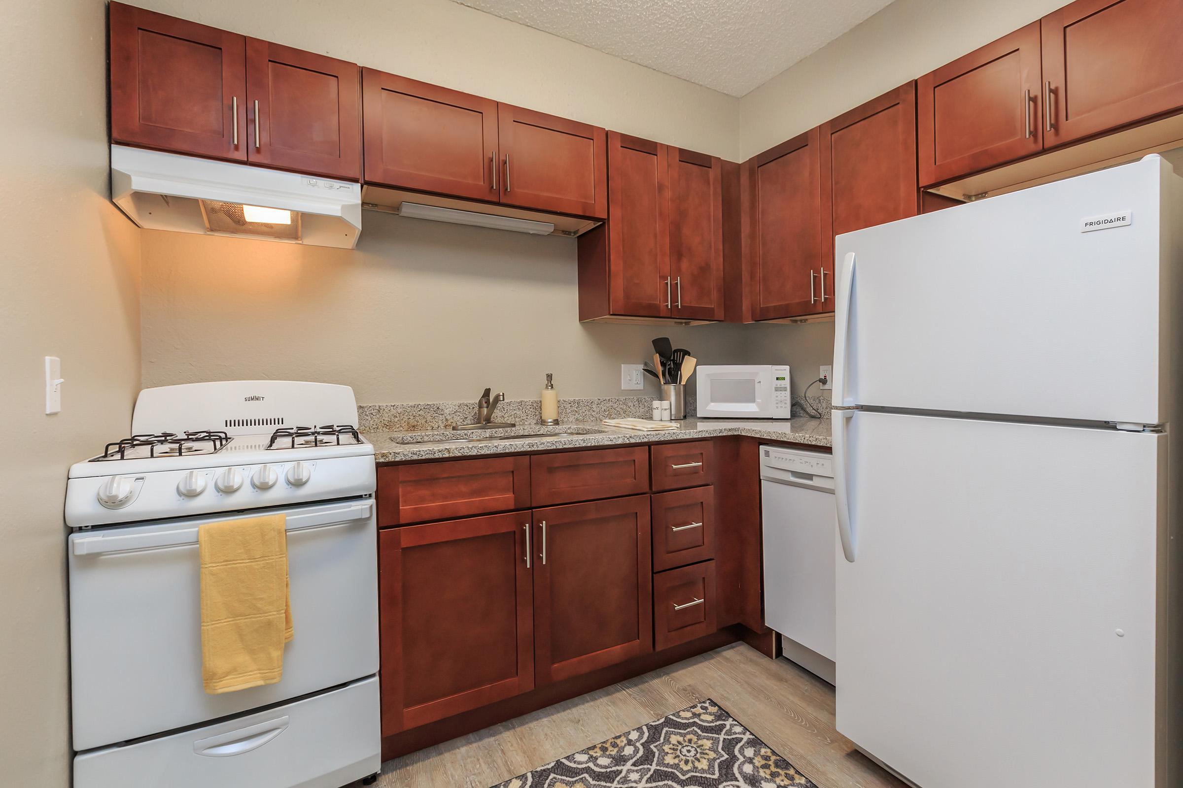 a kitchen with a stove and a refrigerator