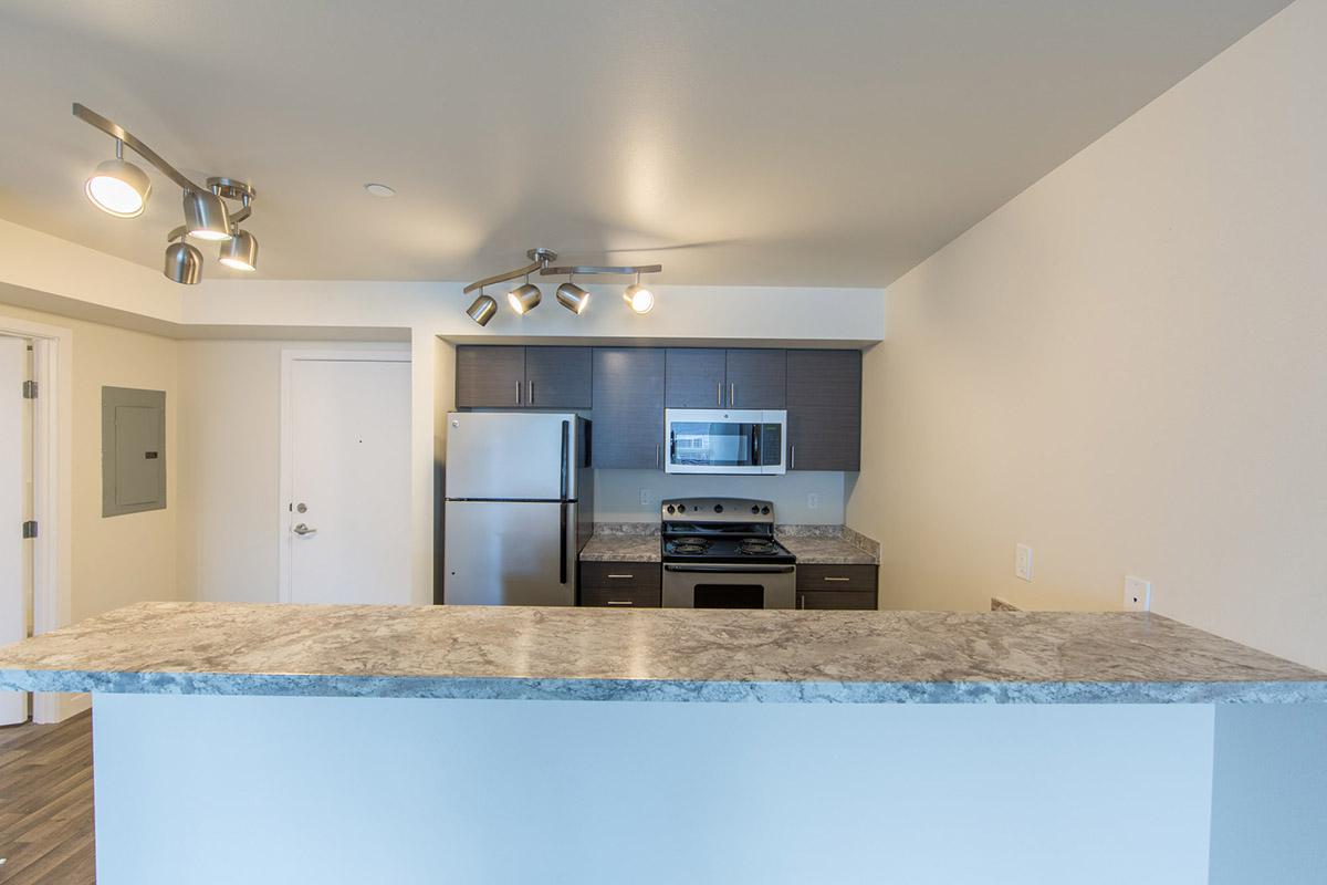 a kitchen with a sink and a mirror