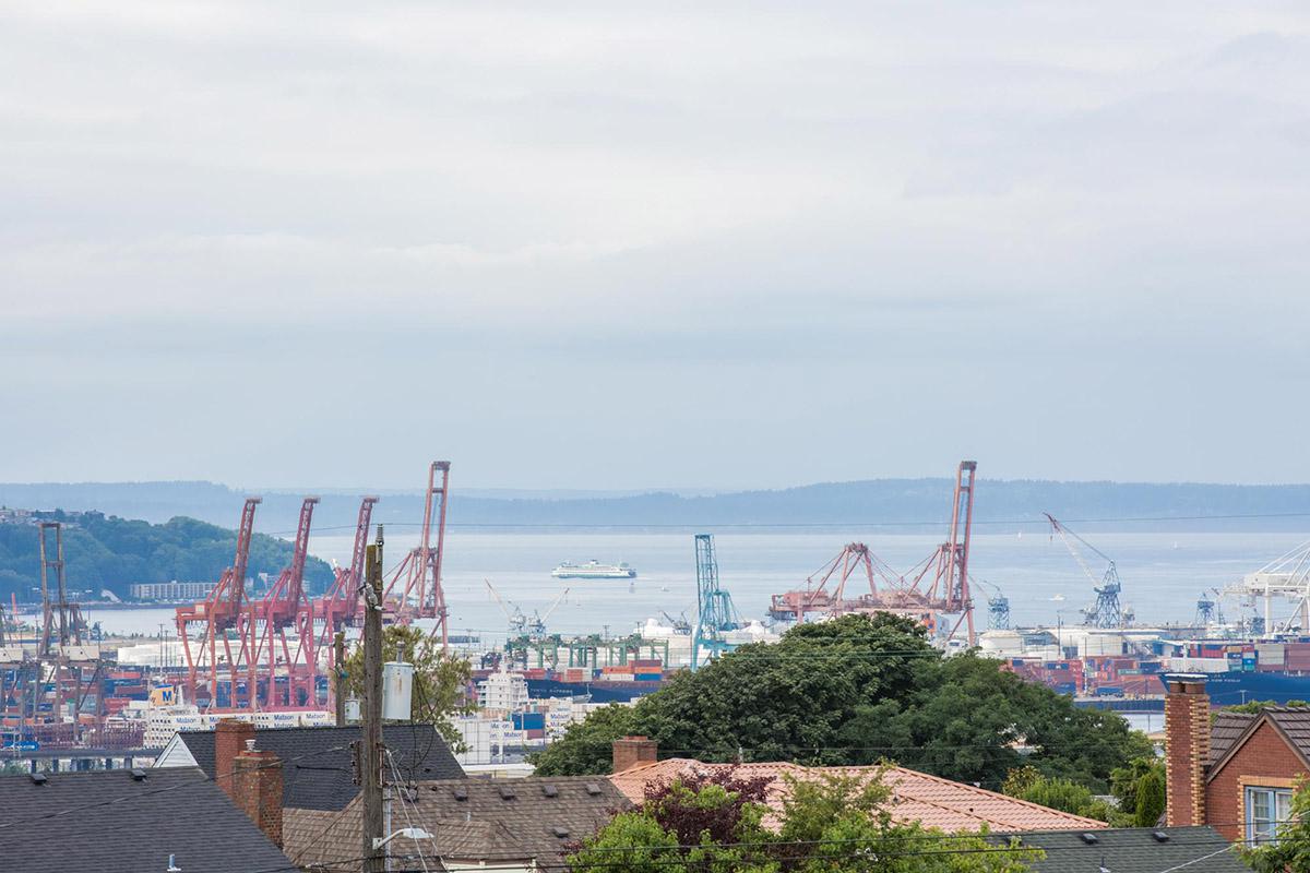 a bridge over a body of water with a city in the background