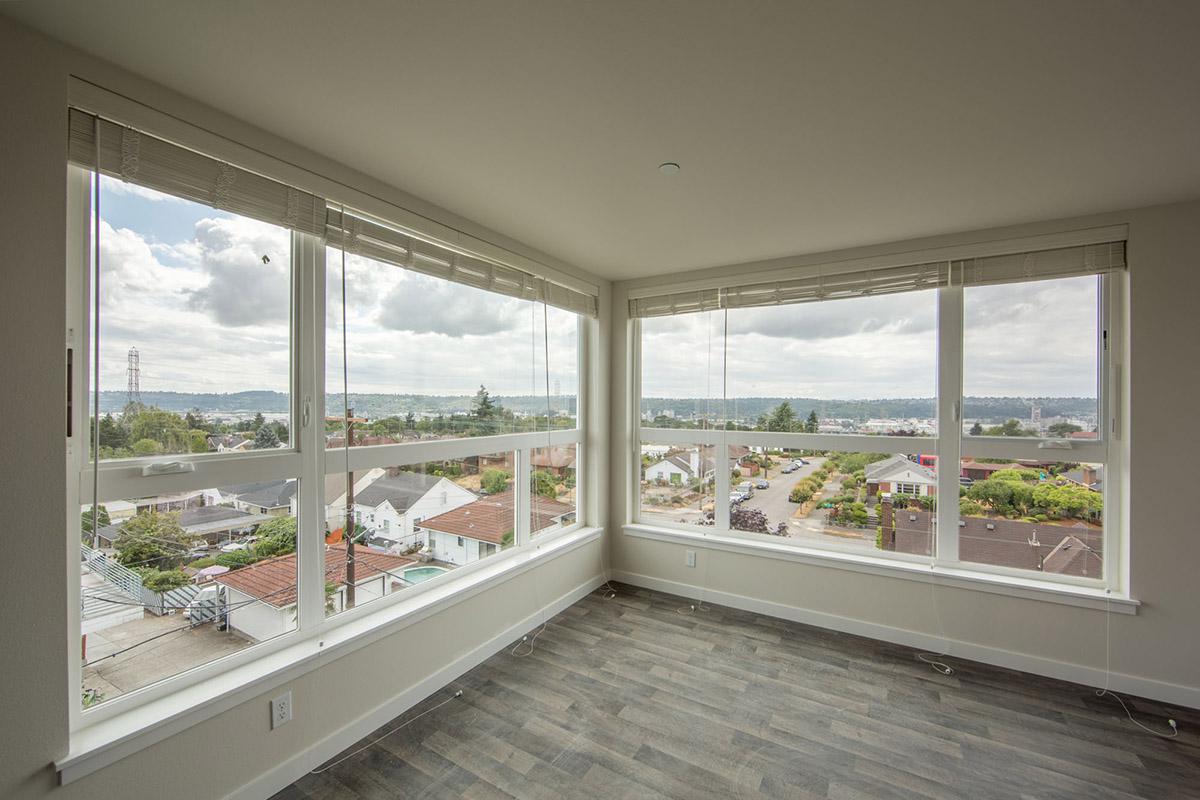 a view of a living room filled with furniture and a large window