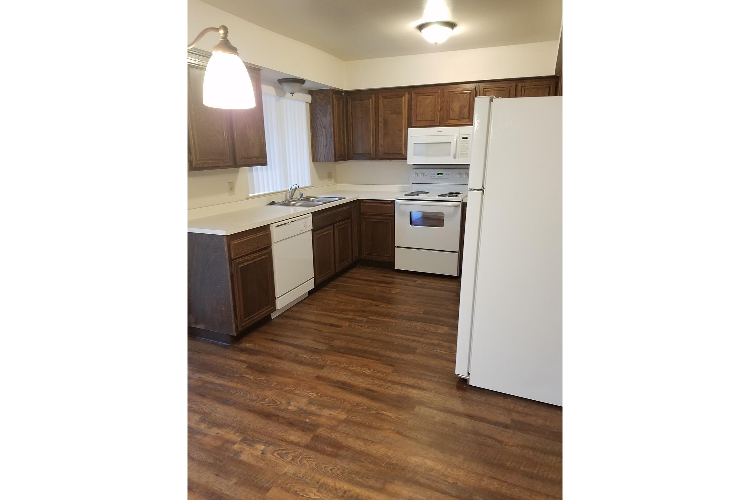 a kitchen with a wood floor