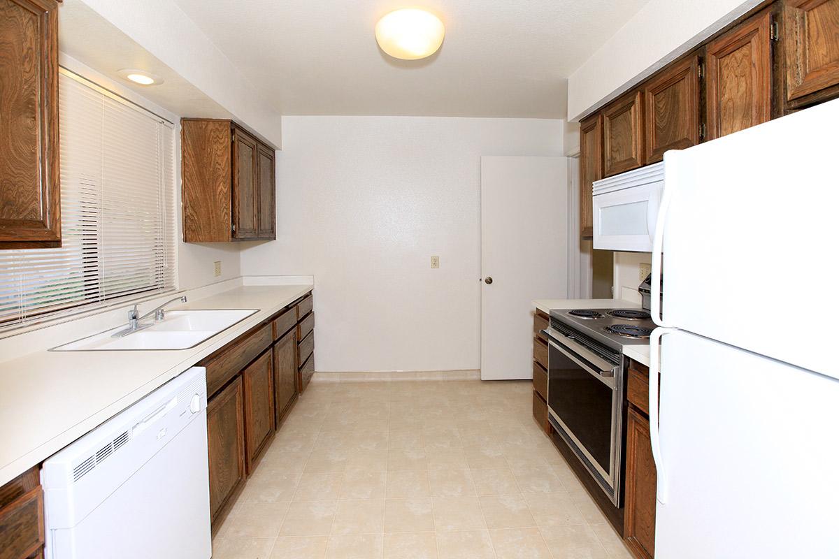 a kitchen with a stove and a refrigerator