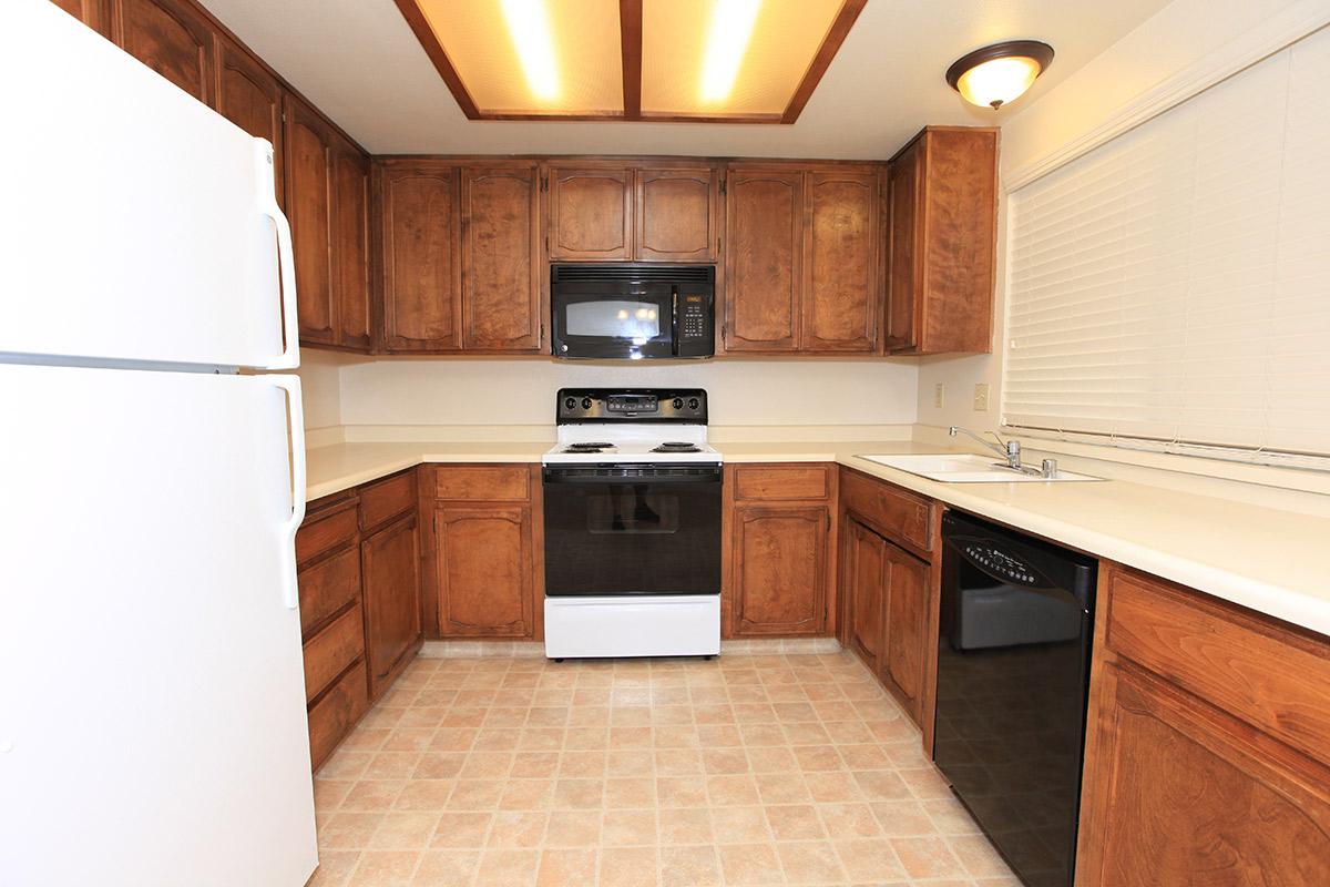 a kitchen with a refrigerator stove and microwave