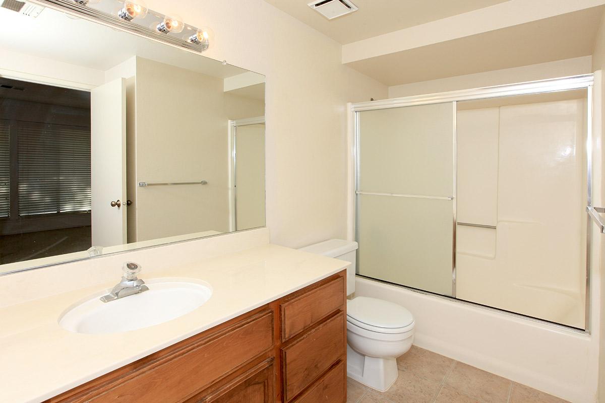 a large white tub sitting next to a sink