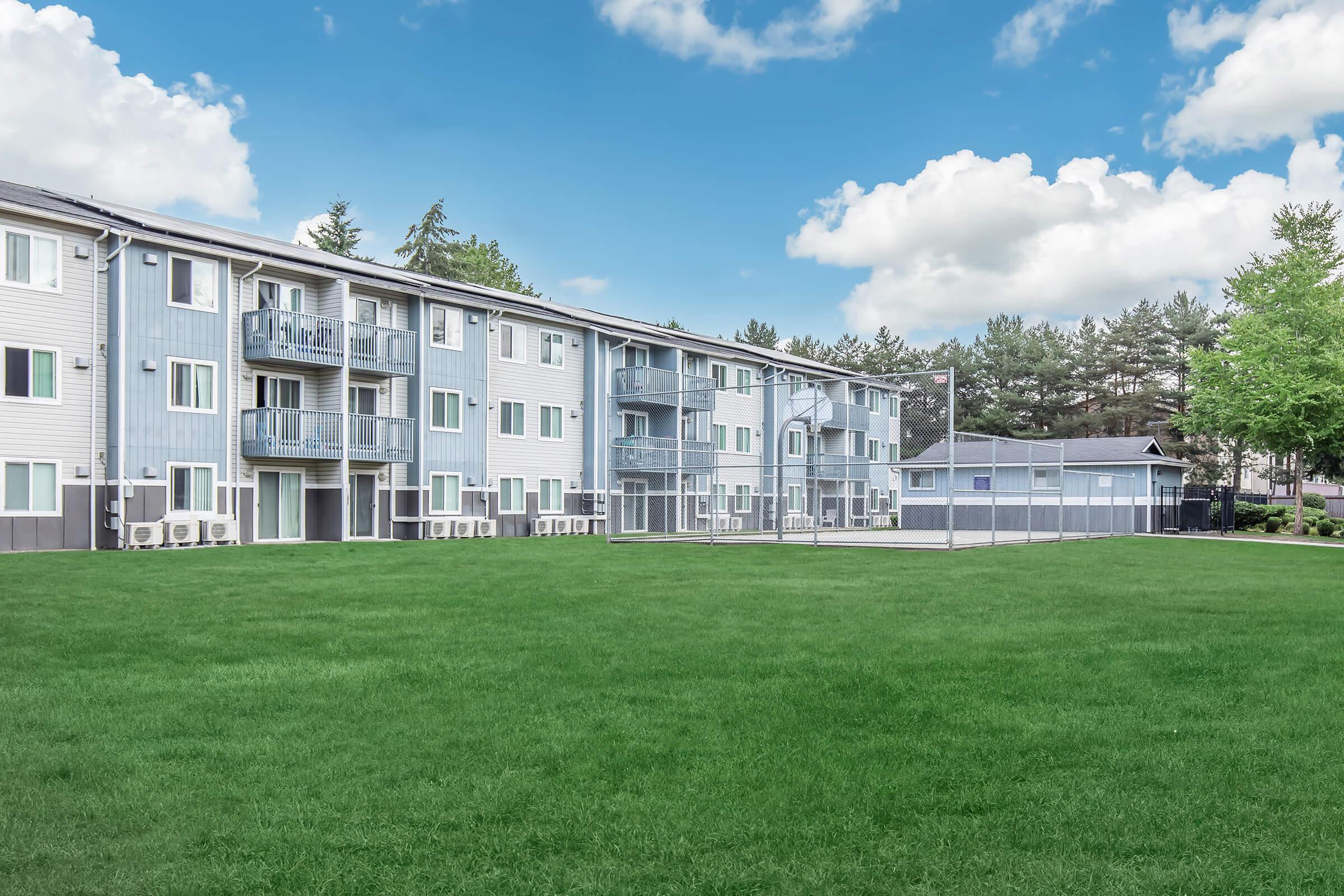 a large building with a grassy field