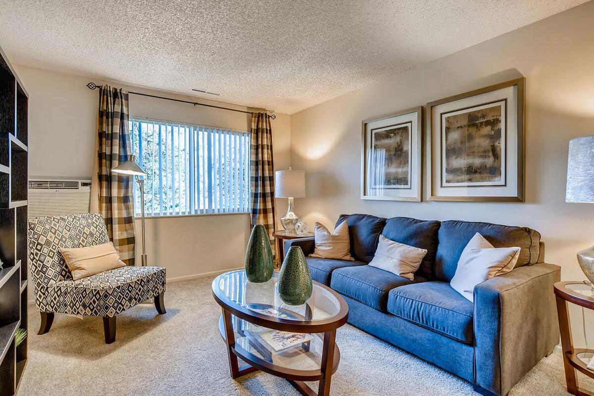 a living room filled with furniture and a large window
