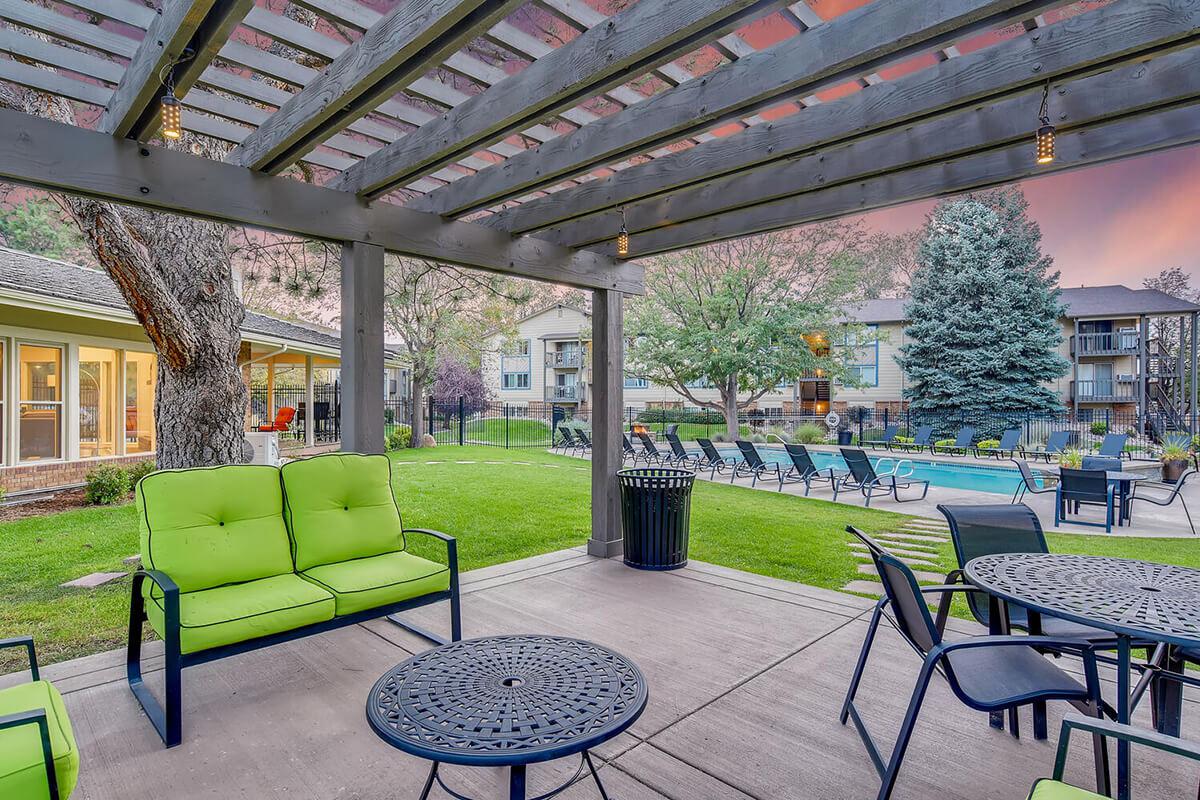 a green bench sitting in front of a building