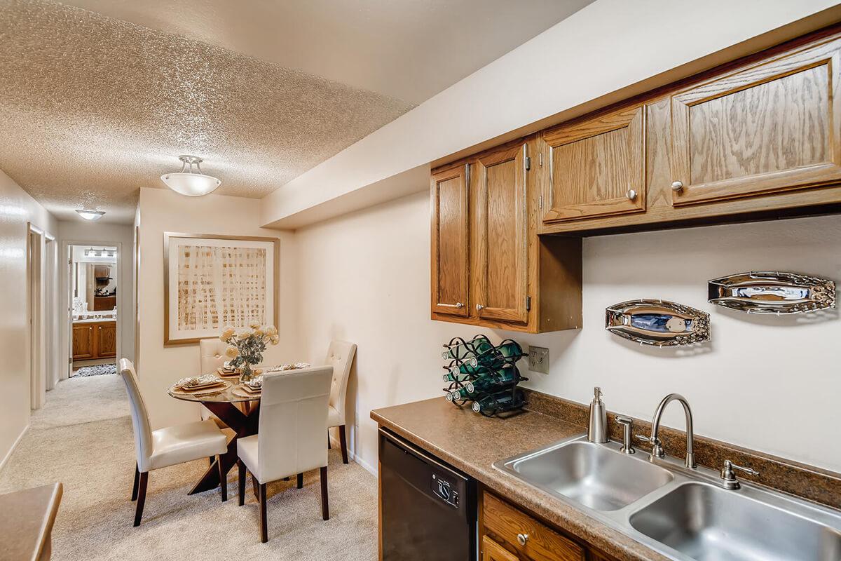 a kitchen with a sink and a dining room table