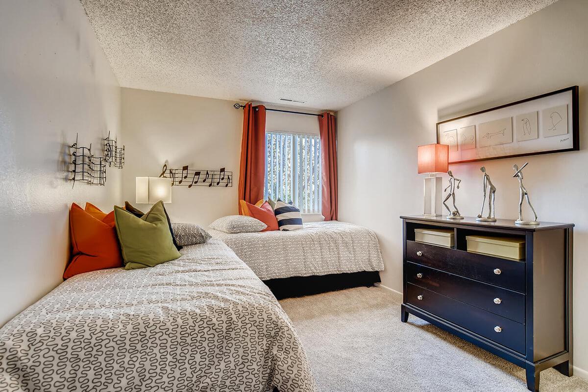 a bedroom with a large bed sitting in a living room