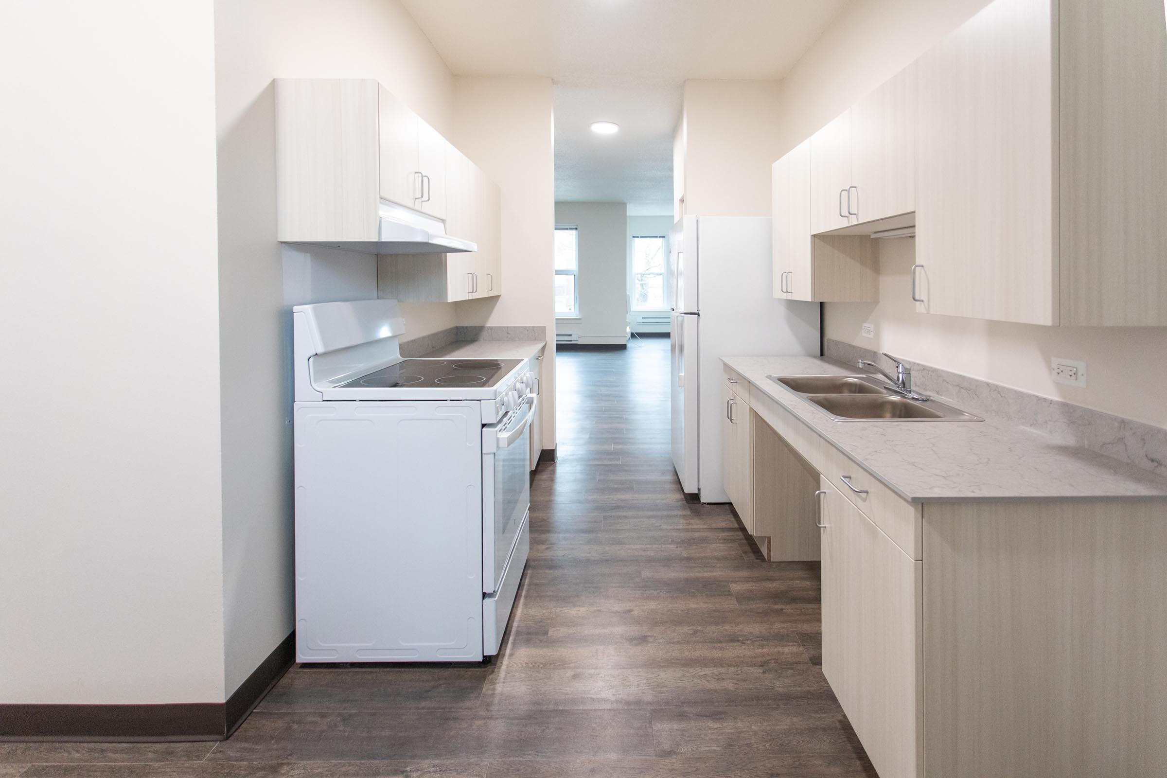 a kitchen with a sink and a refrigerator