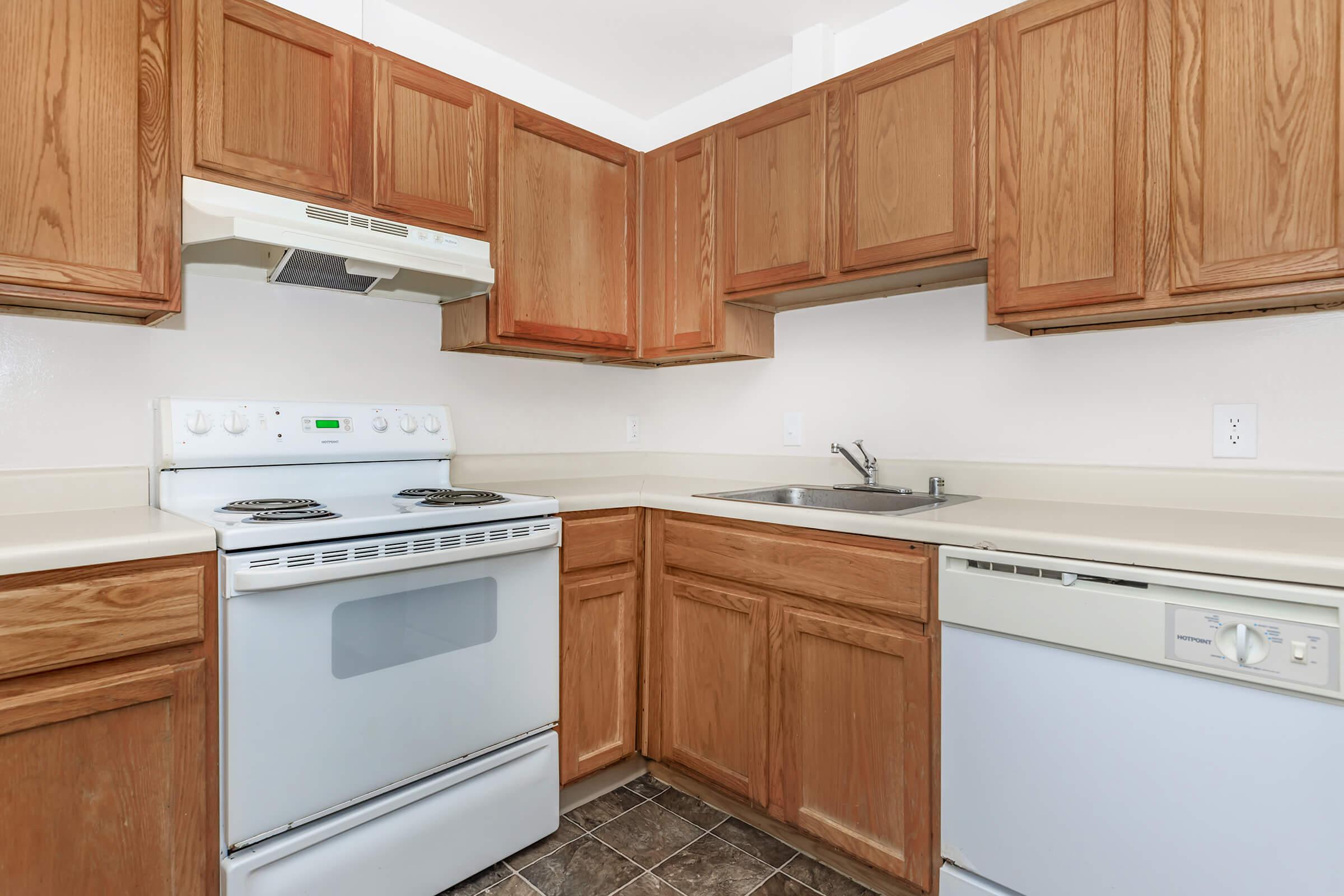 a kitchen with wooden cabinets and a microwave