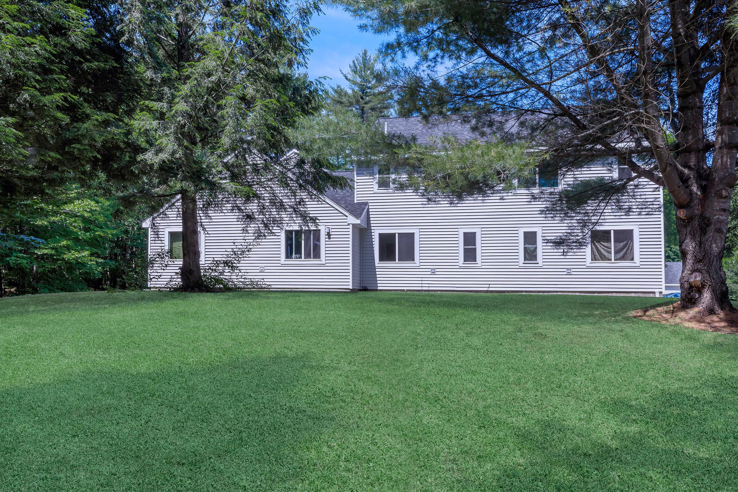 a green lawn in front of a house