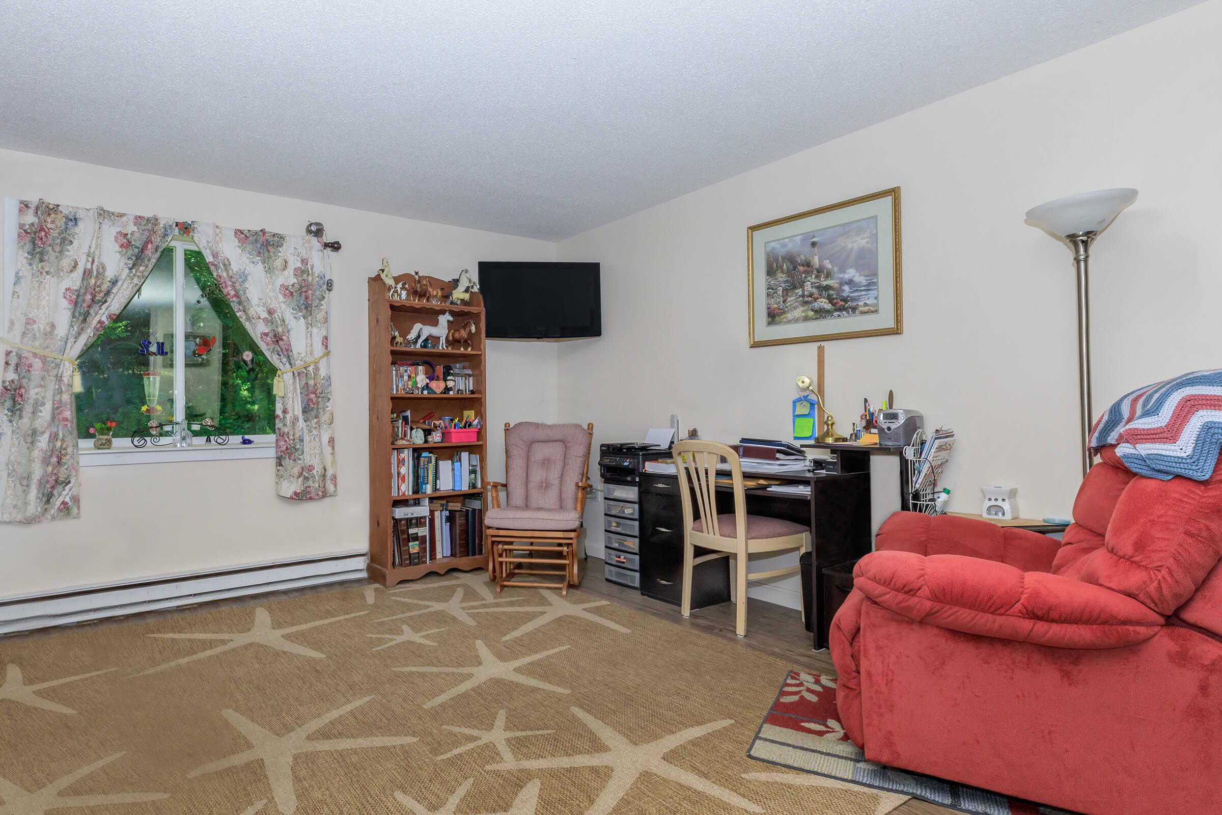 a living room filled with furniture and a flat screen tv