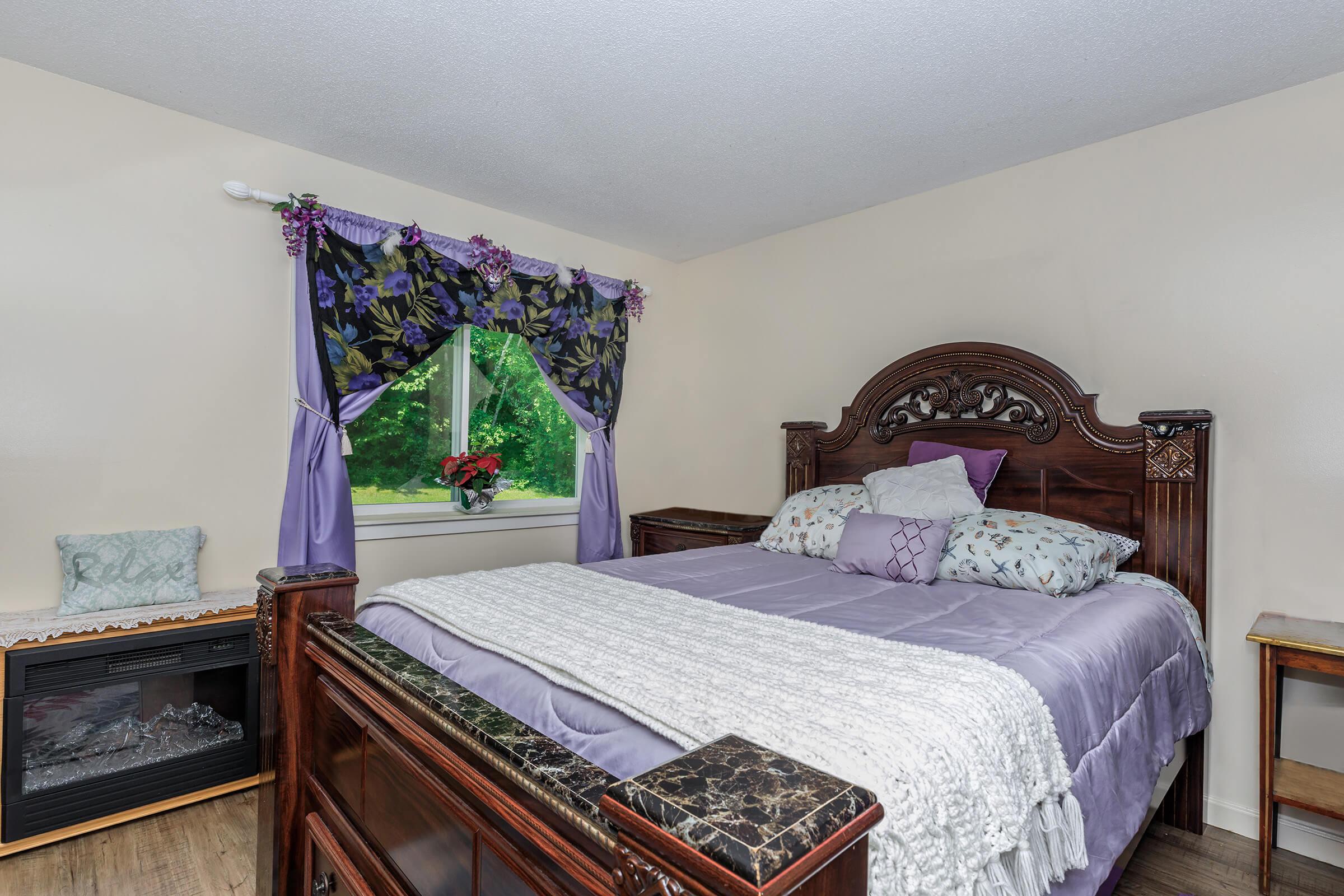 a bedroom with a bed and desk in a room