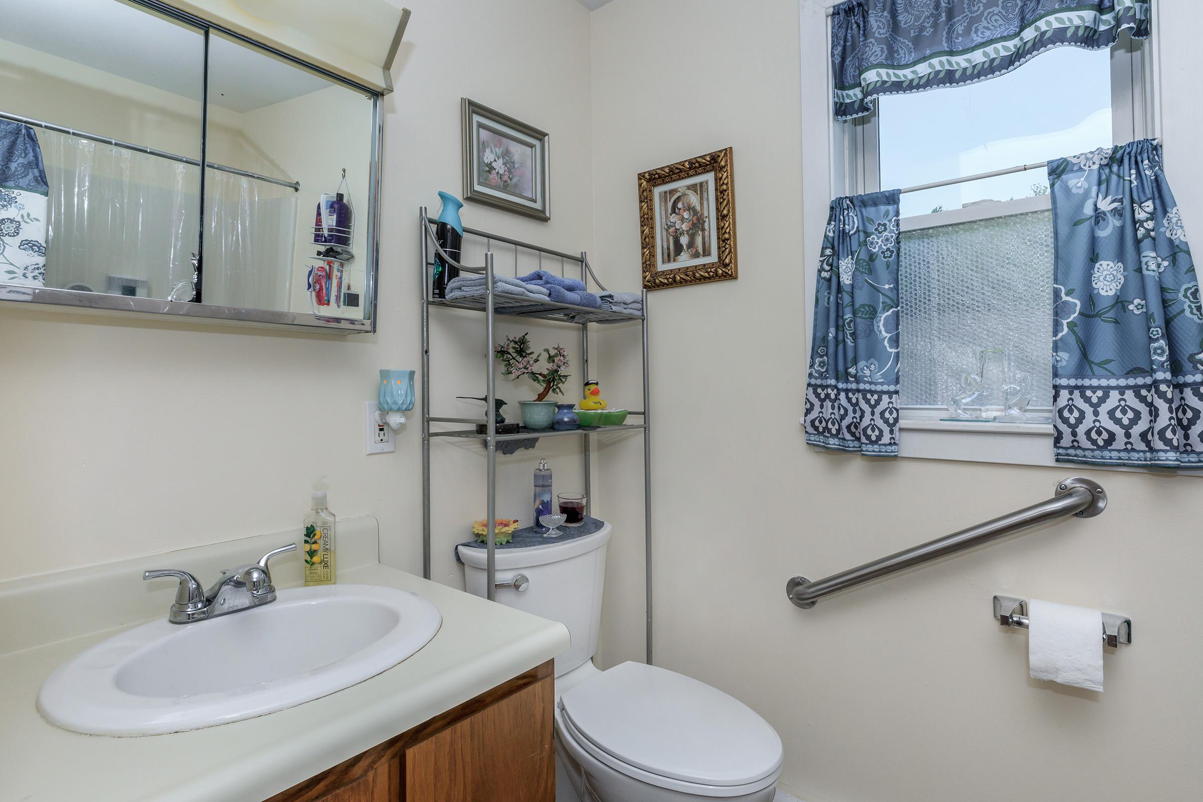 a white sink and a mirror