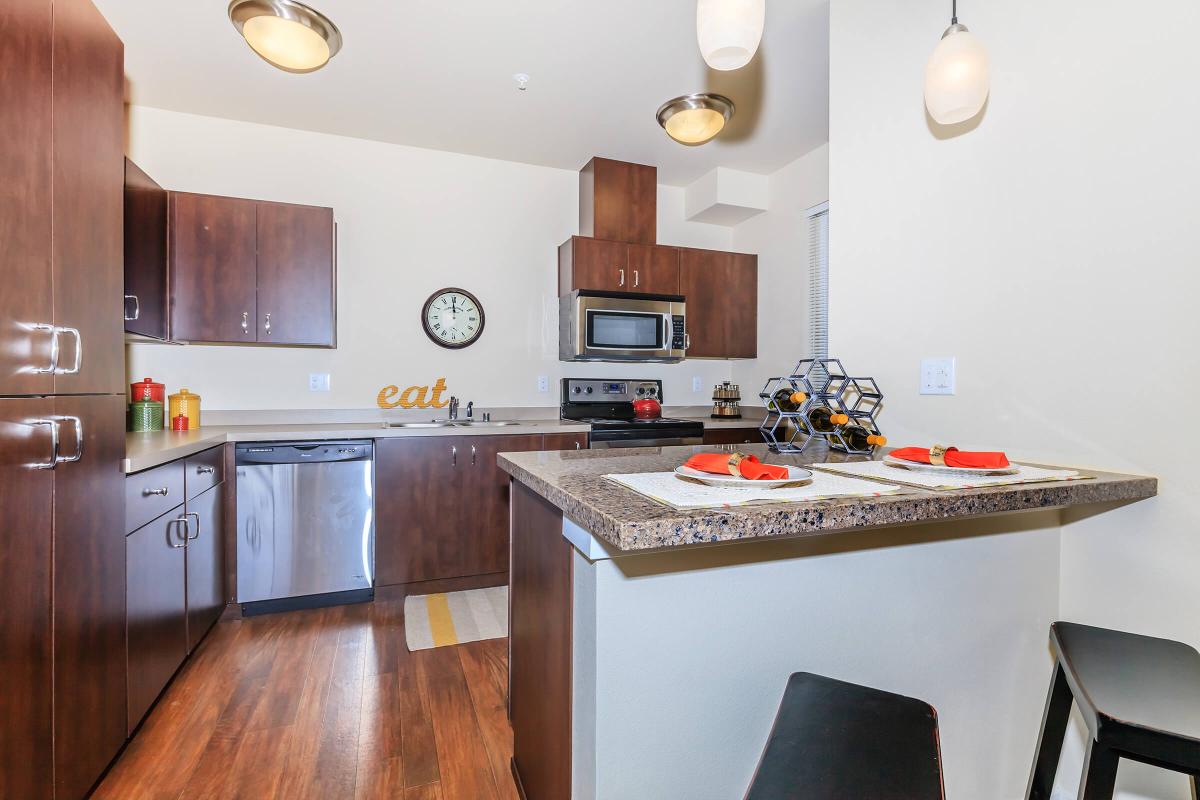 a modern kitchen with stainless steel appliances and wooden cabinets