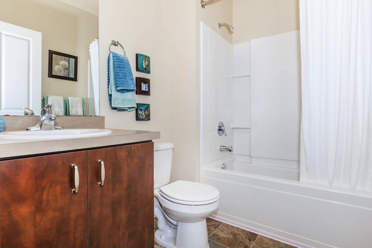 a white tub sitting next to a sink