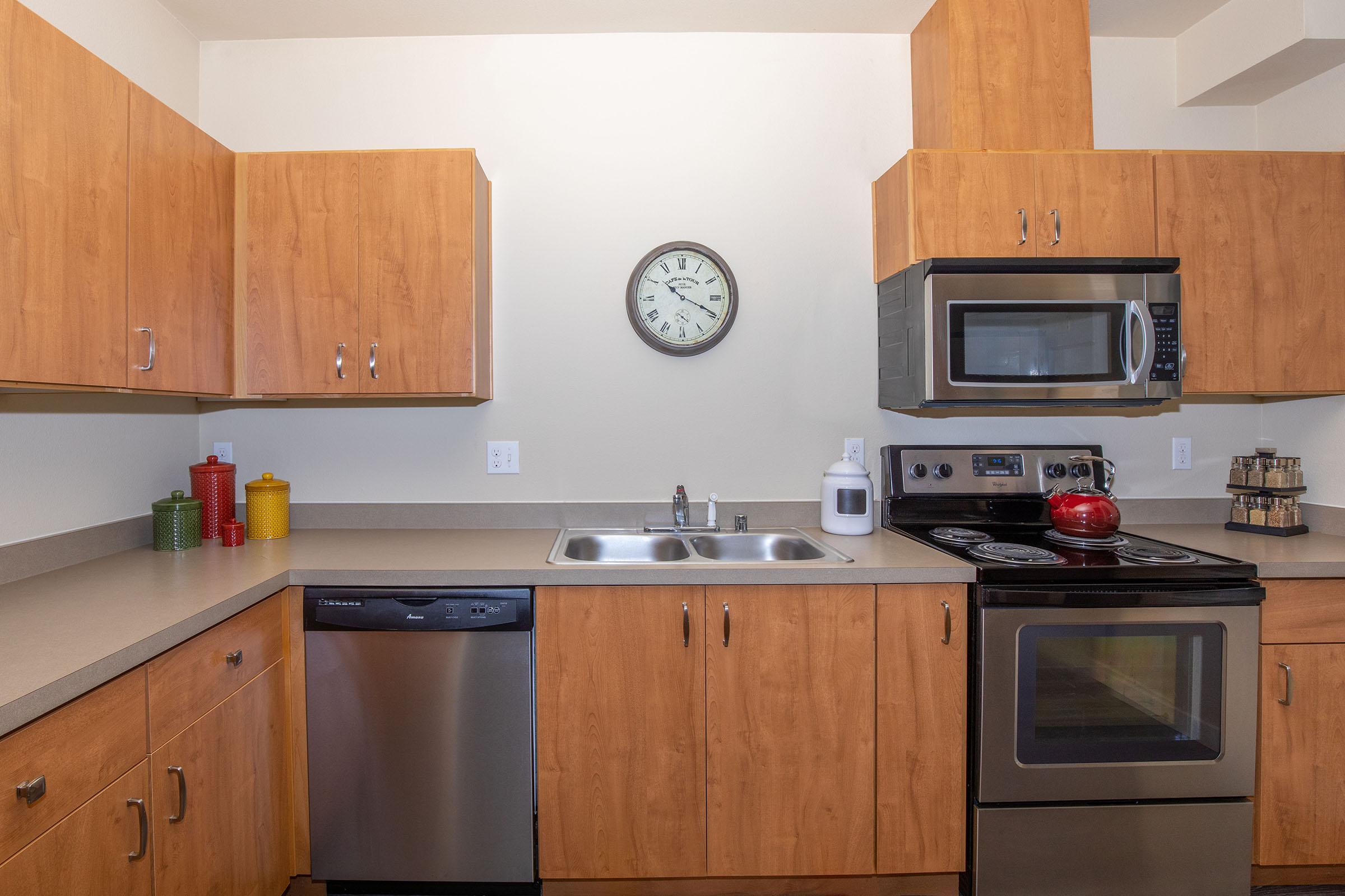 a kitchen with a stove top oven sitting next to a microwave