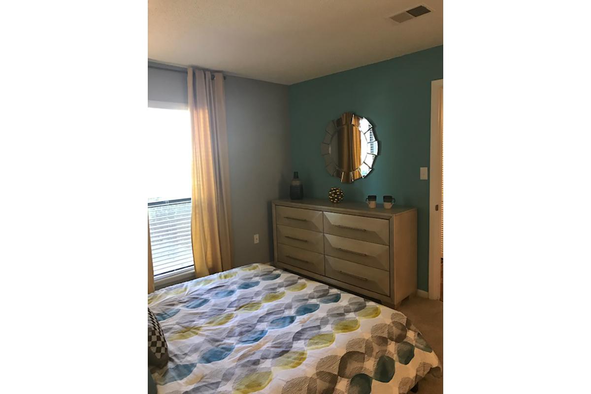 a bedroom with a bed and a mirror
