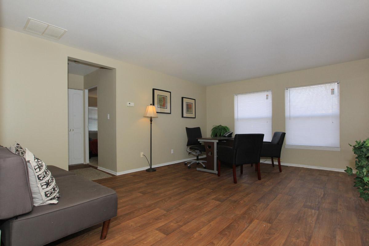 a living room filled with furniture and a flat screen tv