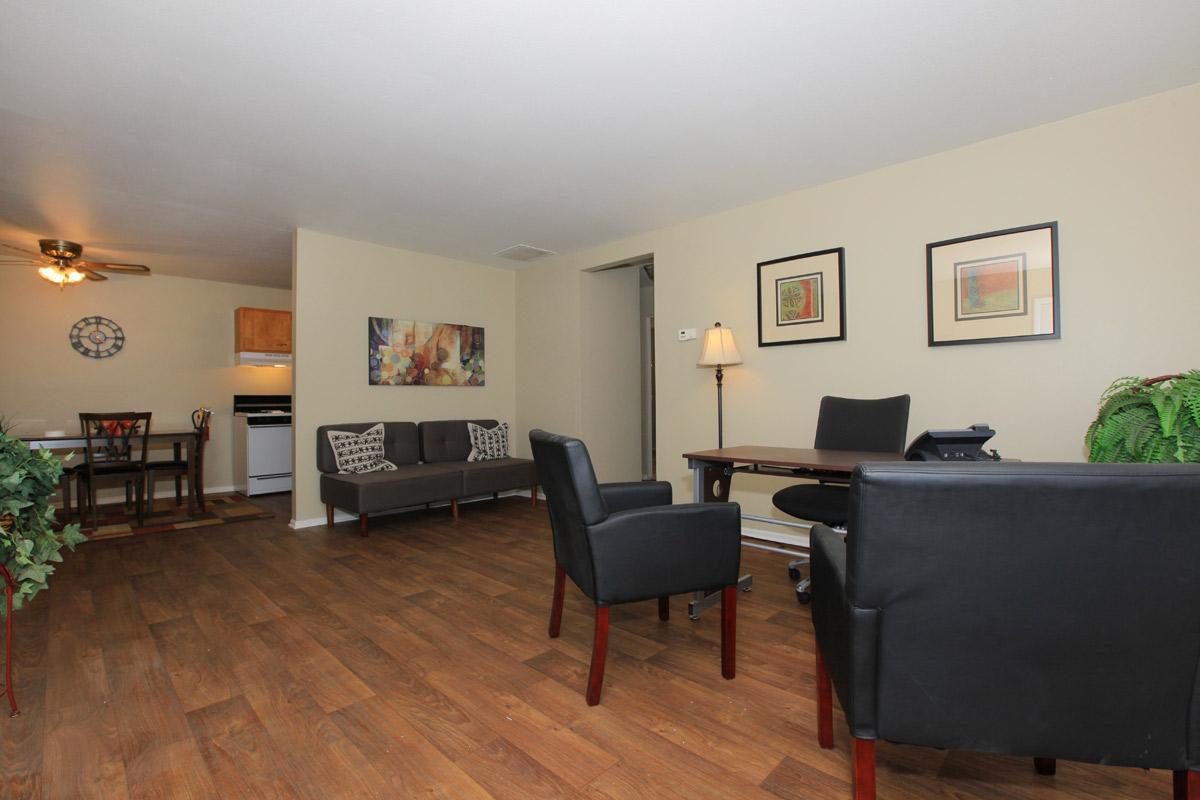 a living room filled with furniture and a wood floor