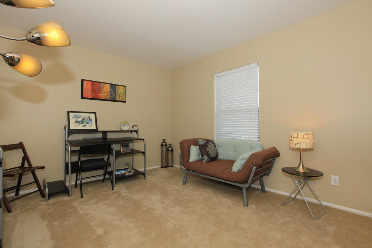 a living room filled with furniture and a table