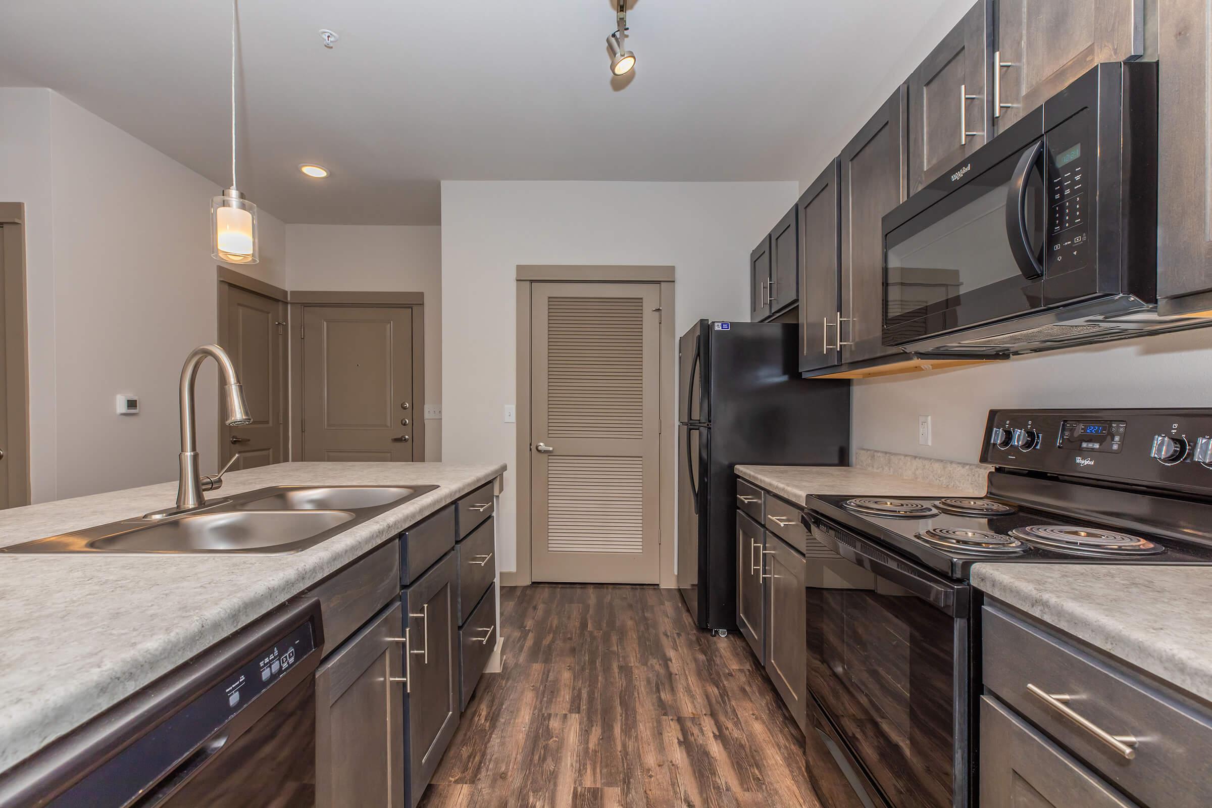 a large kitchen with stainless steel appliances