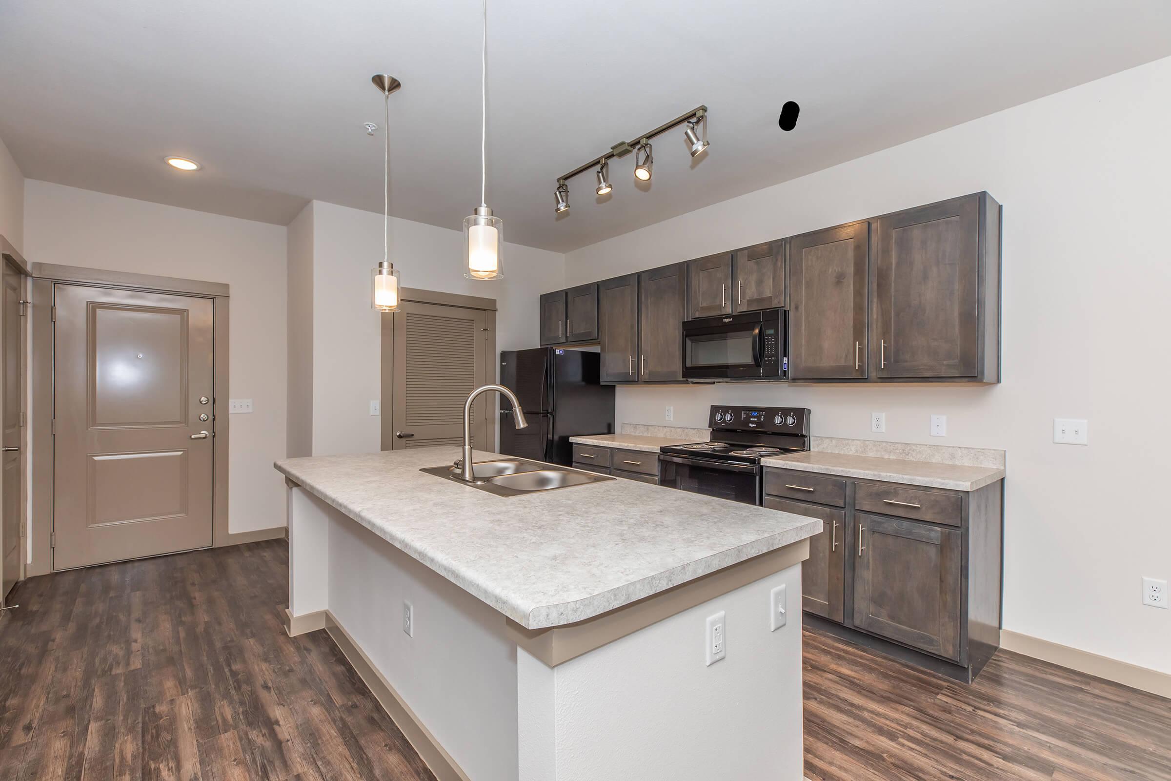 a modern kitchen with stainless steel appliances and wooden cabinets