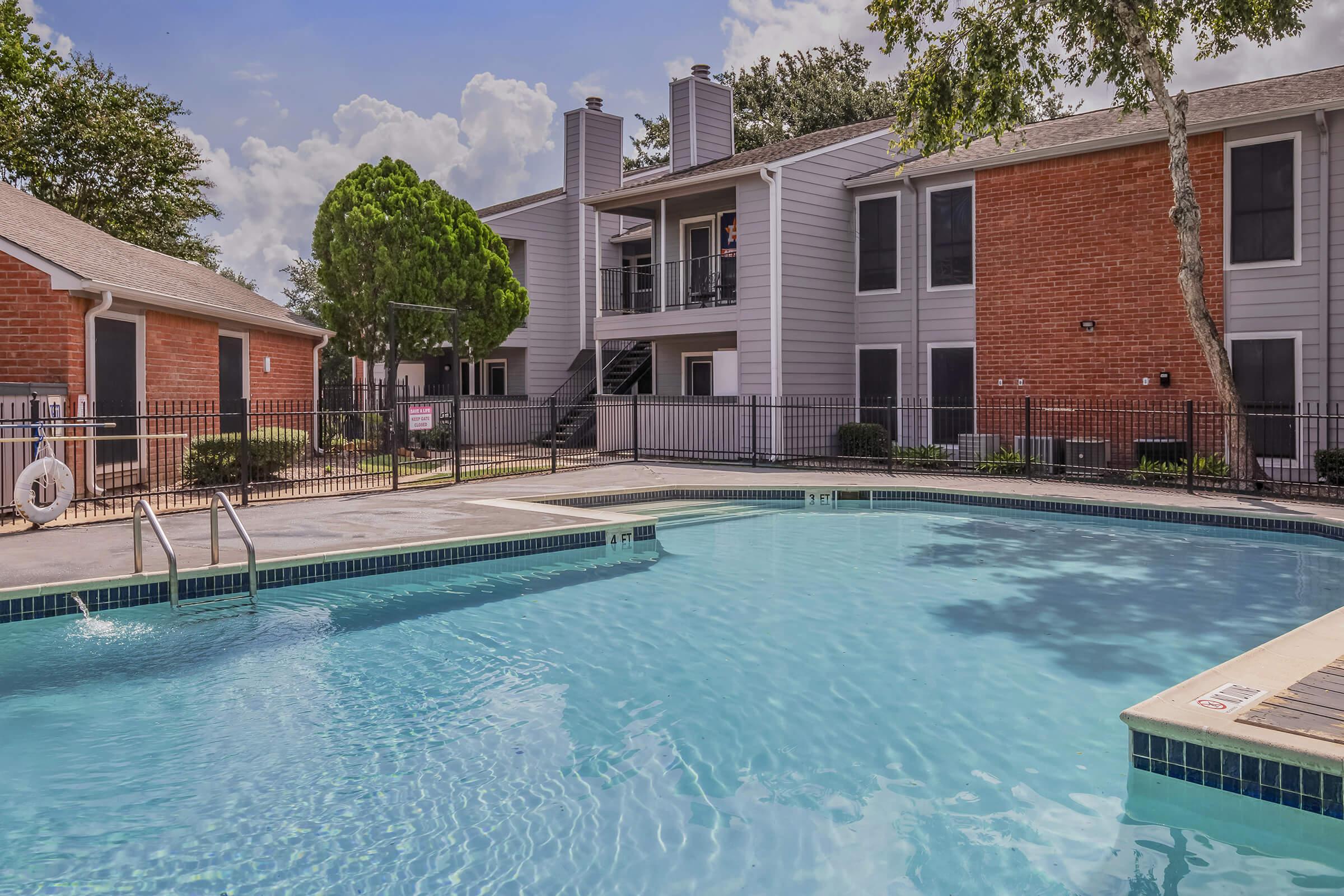 a large pool of water in front of a house