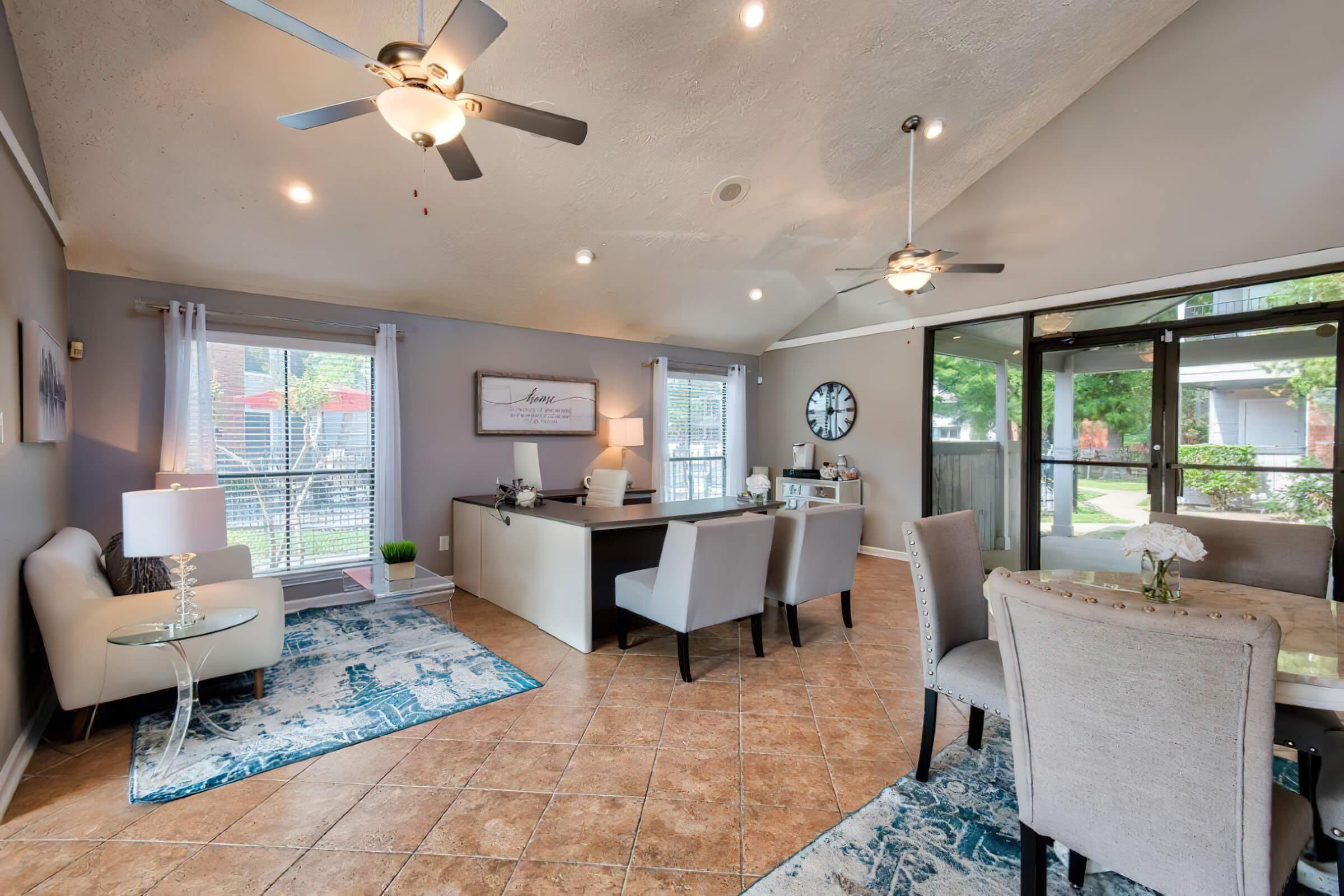 a living room filled with furniture and a large window