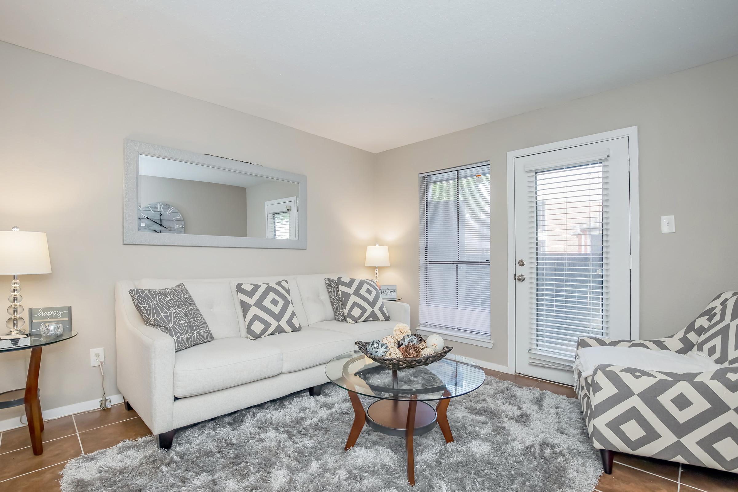 a bedroom with a bed and a chair in a room