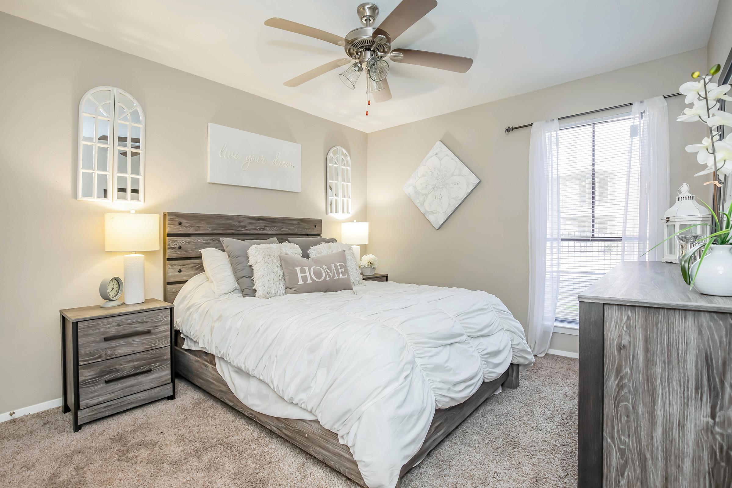 a bedroom with a bed and desk in a room