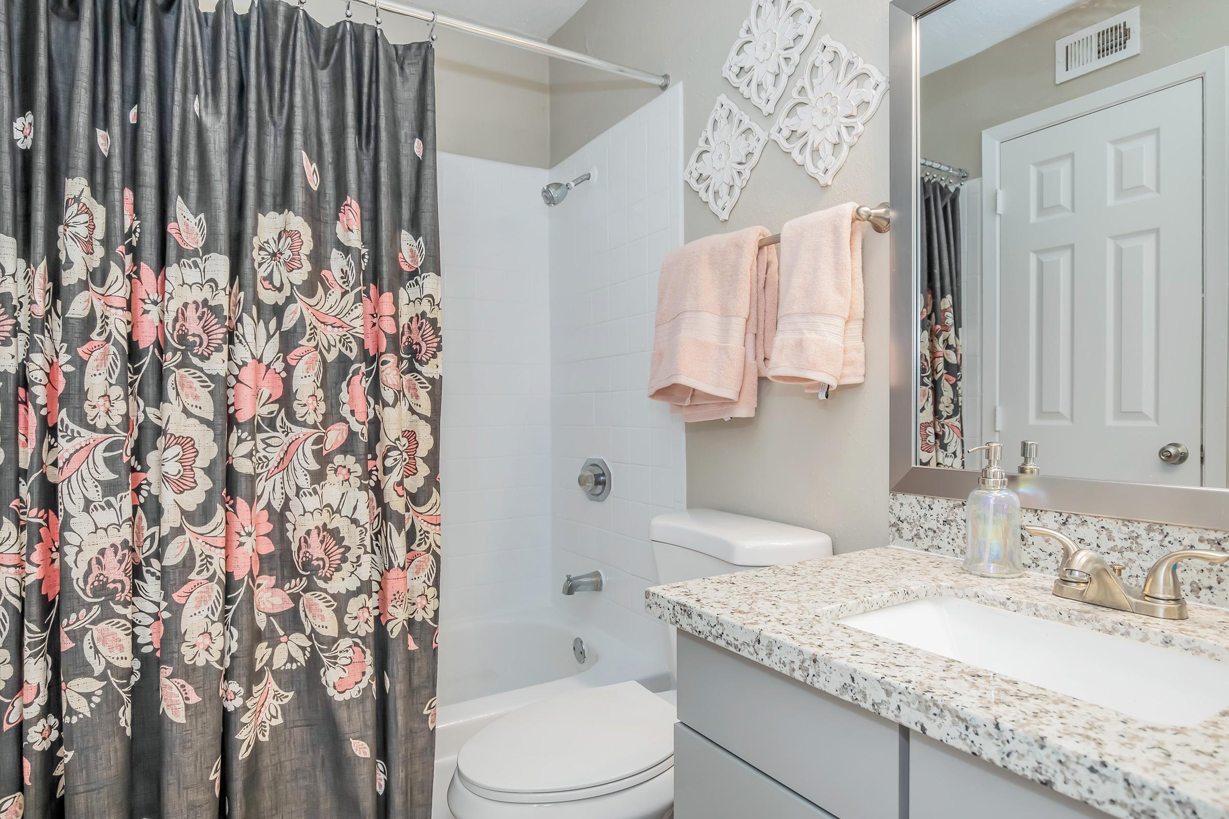 a shower curtain next to a sink