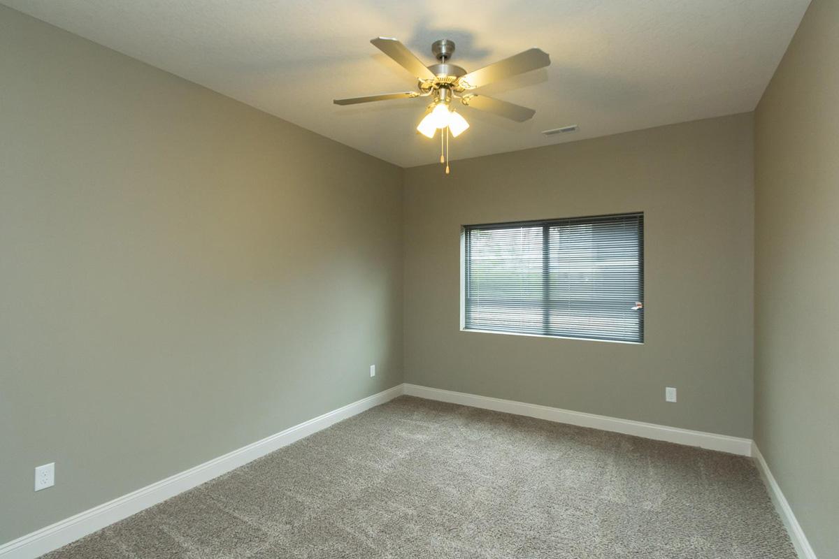 a large empty room with a sink and a mirror