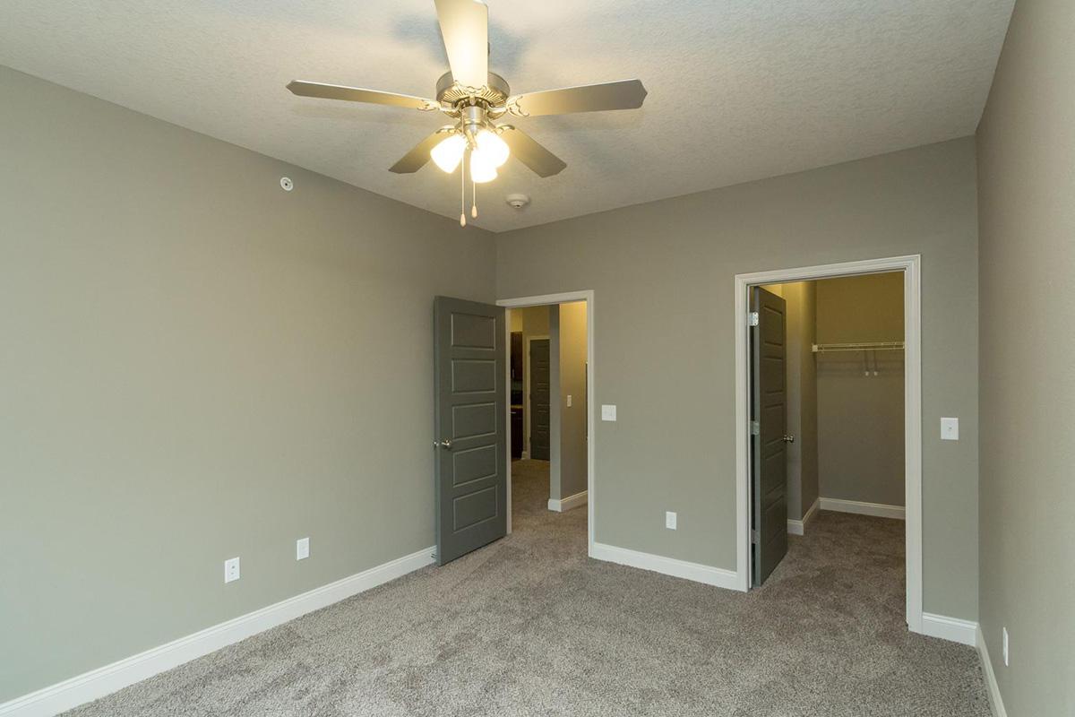 a large empty room with a sink and a mirror