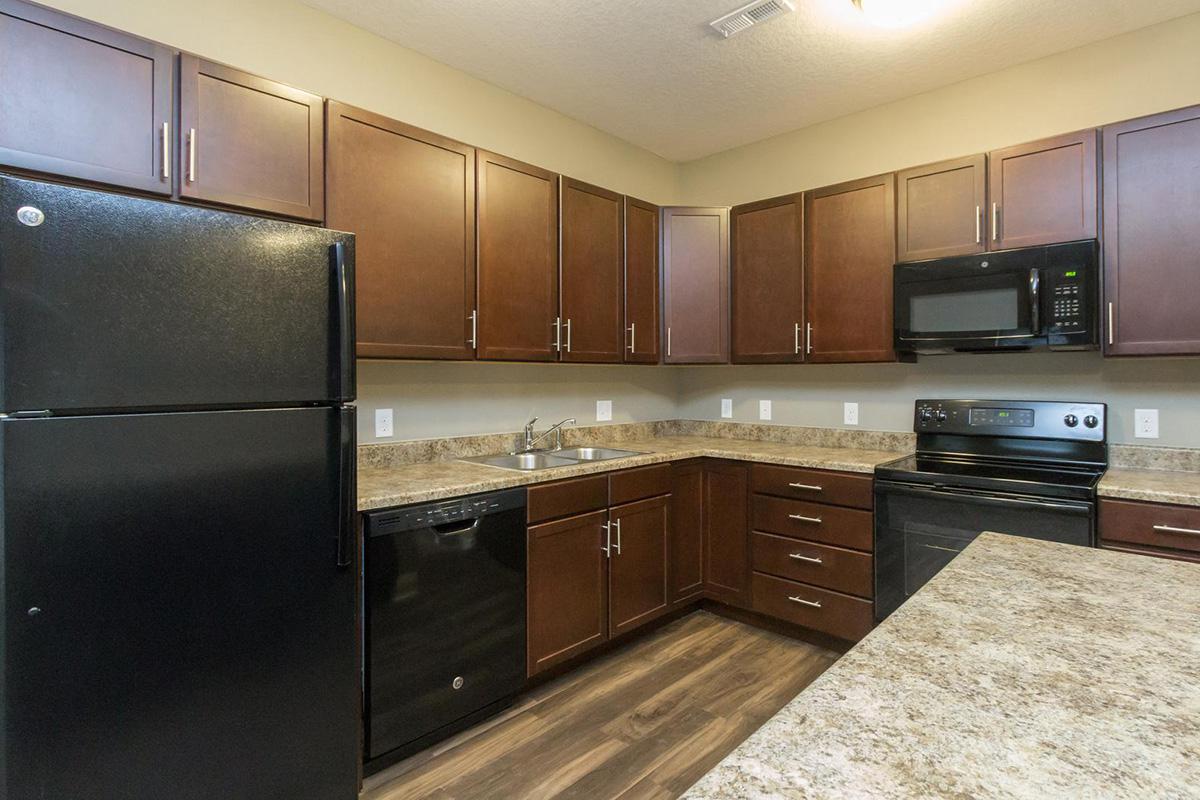 a modern kitchen with stainless steel appliances and wooden cabinets