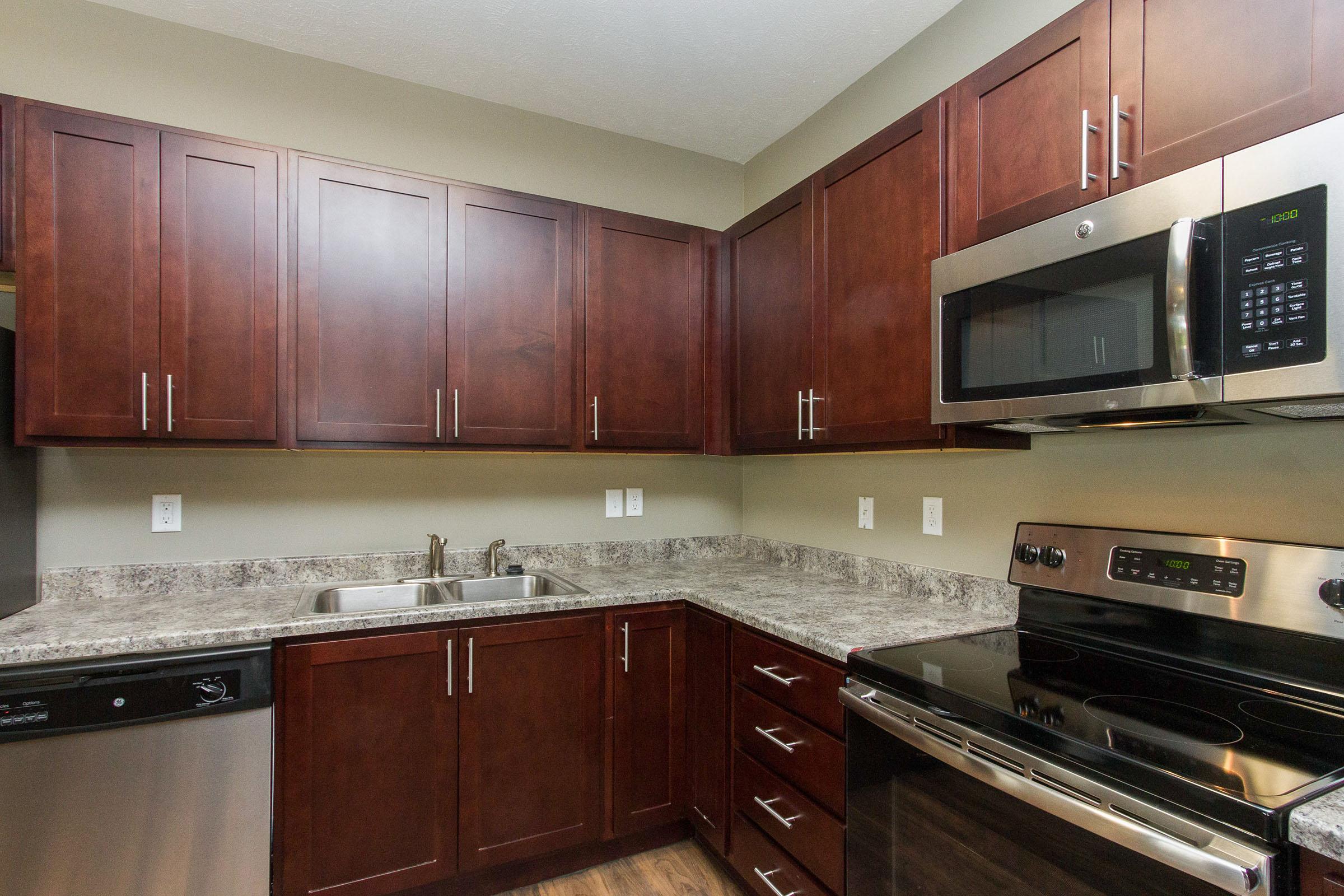 a kitchen with stainless steel appliances and wooden cabinets