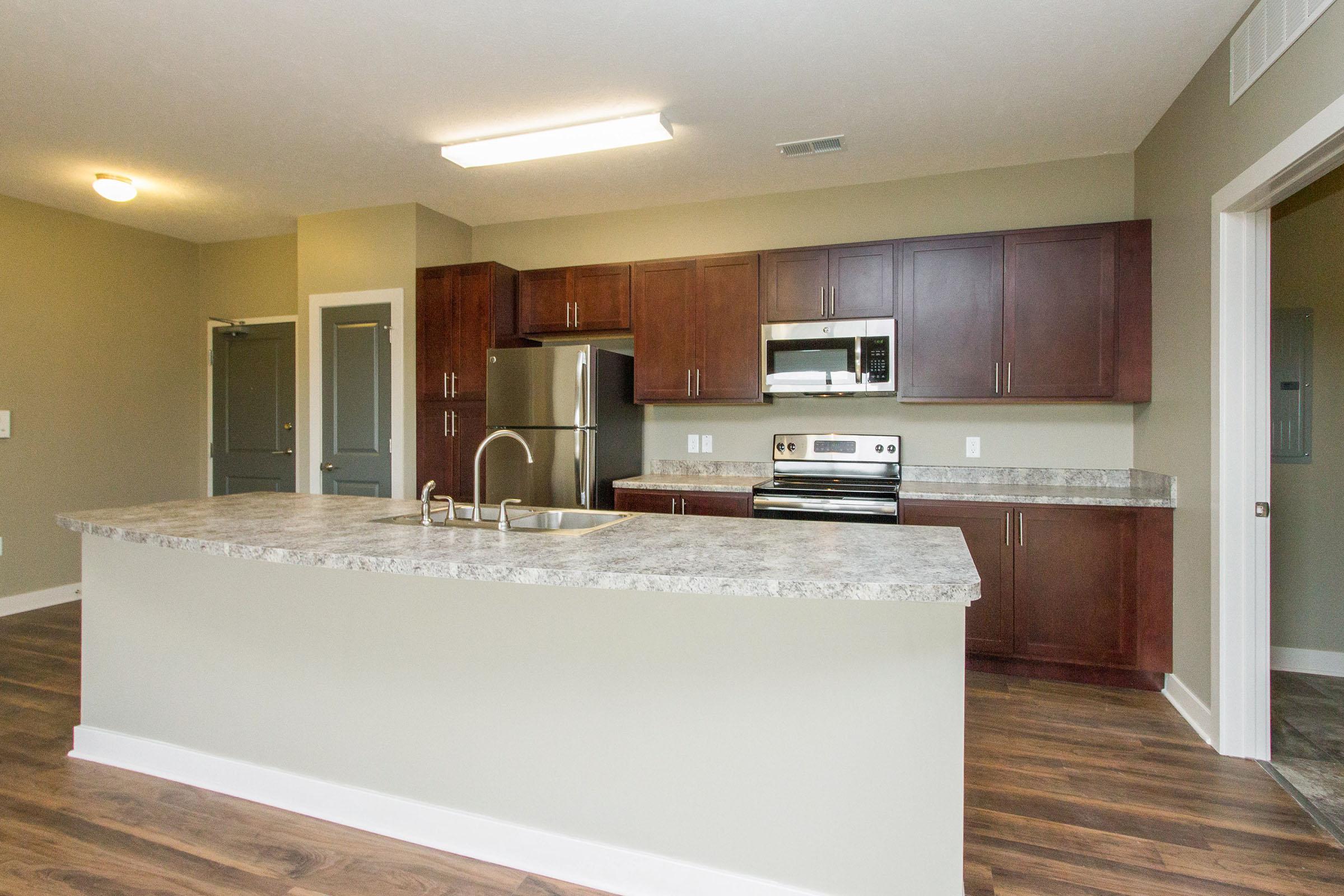 a large kitchen with an island in the middle of a room