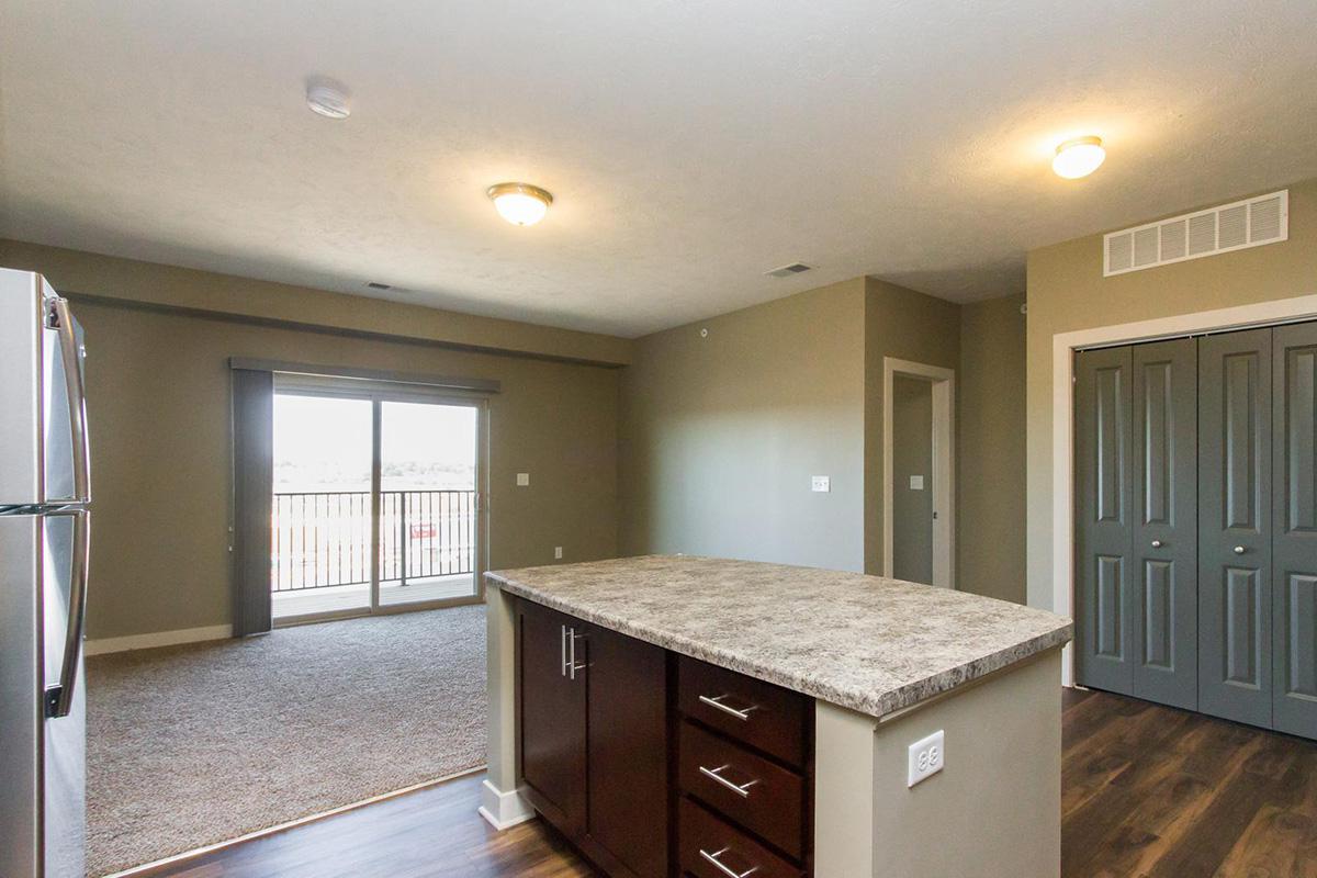 a kitchen with an island in the middle of a room