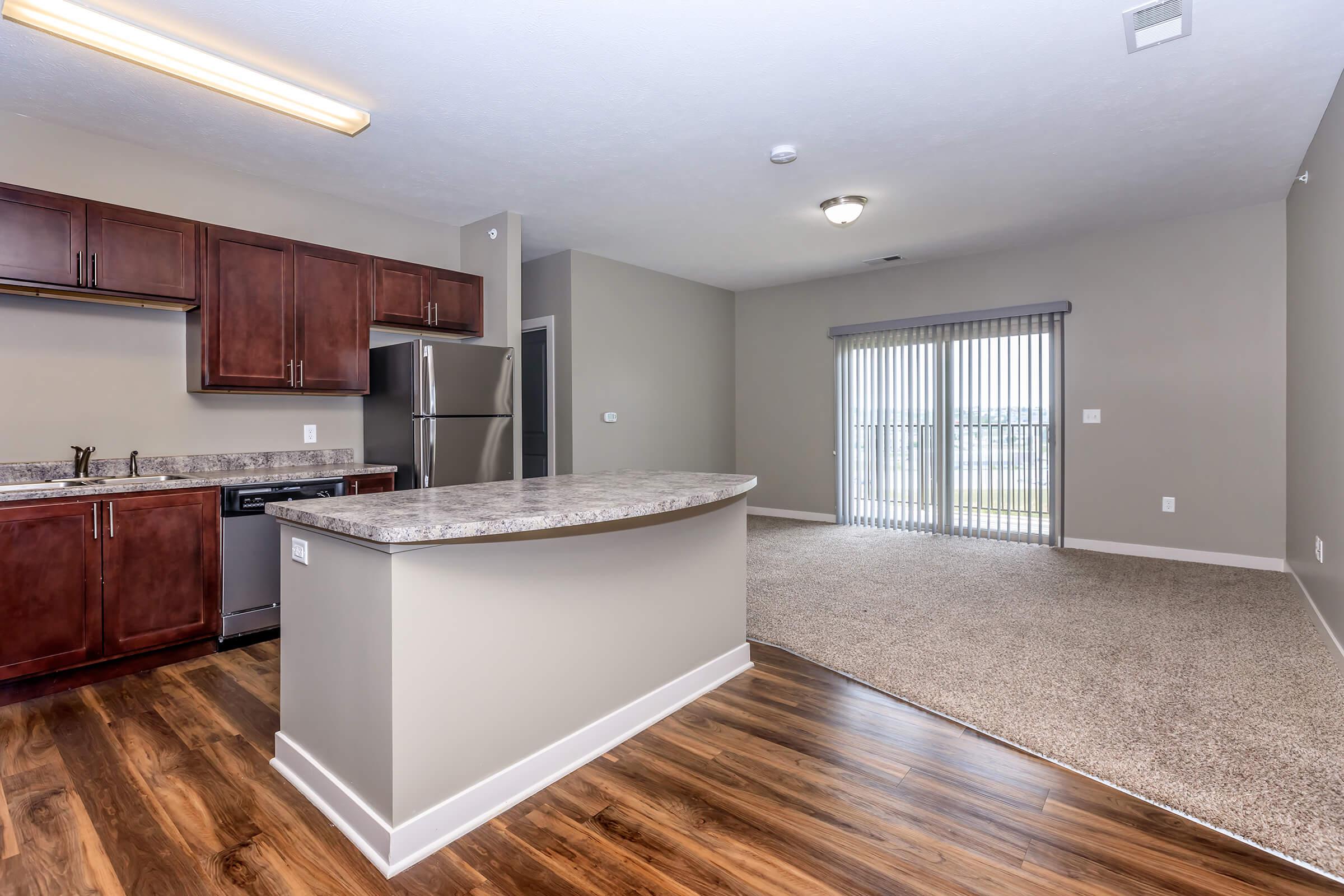 a large kitchen with an island in the middle of a room