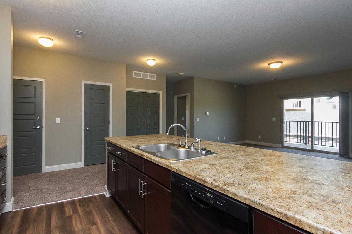 a large kitchen with stainless steel appliances and wooden cabinets