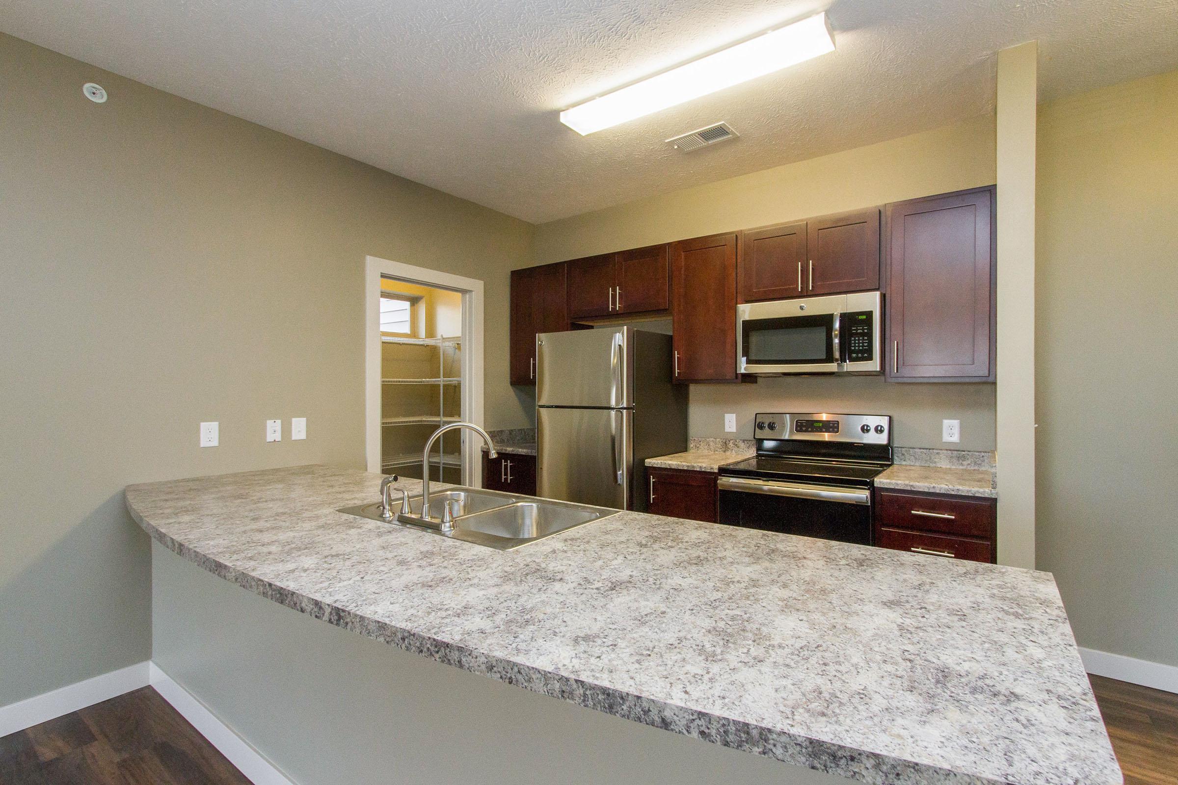 a kitchen with a sink and a mirror