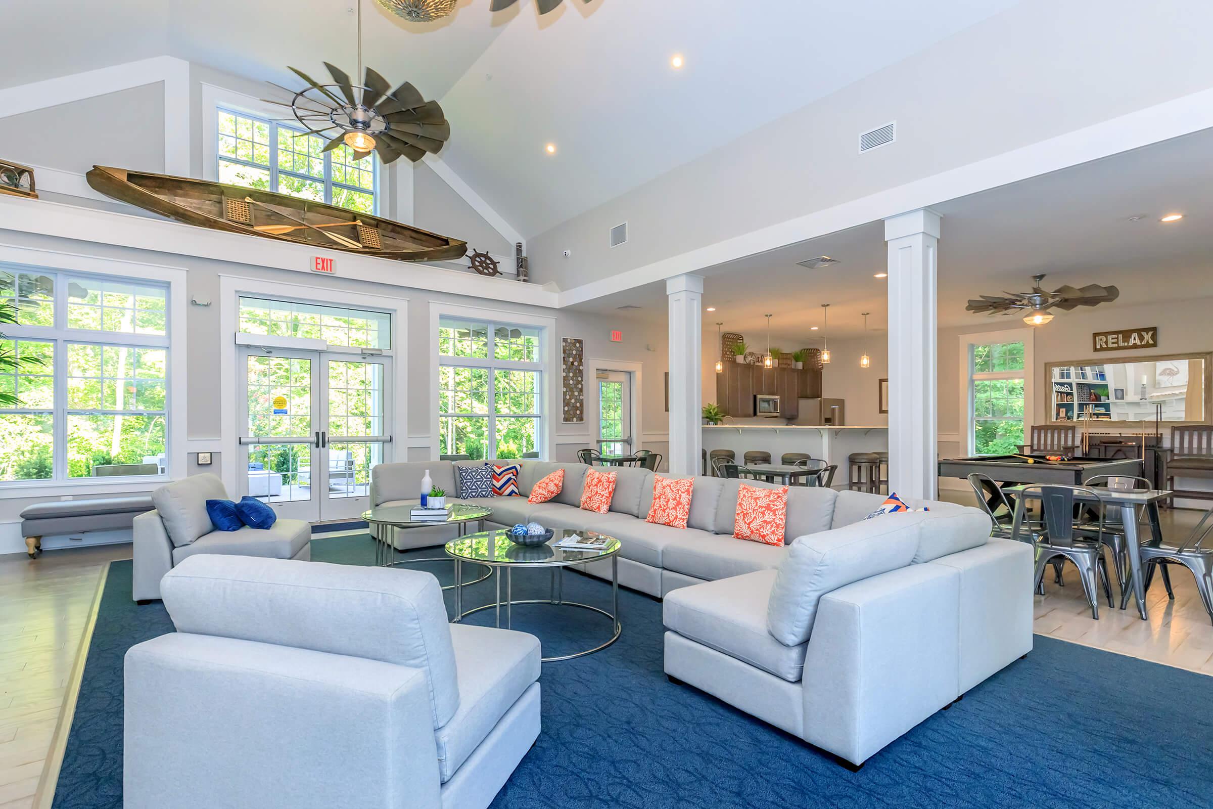 a living room filled with furniture and a large window