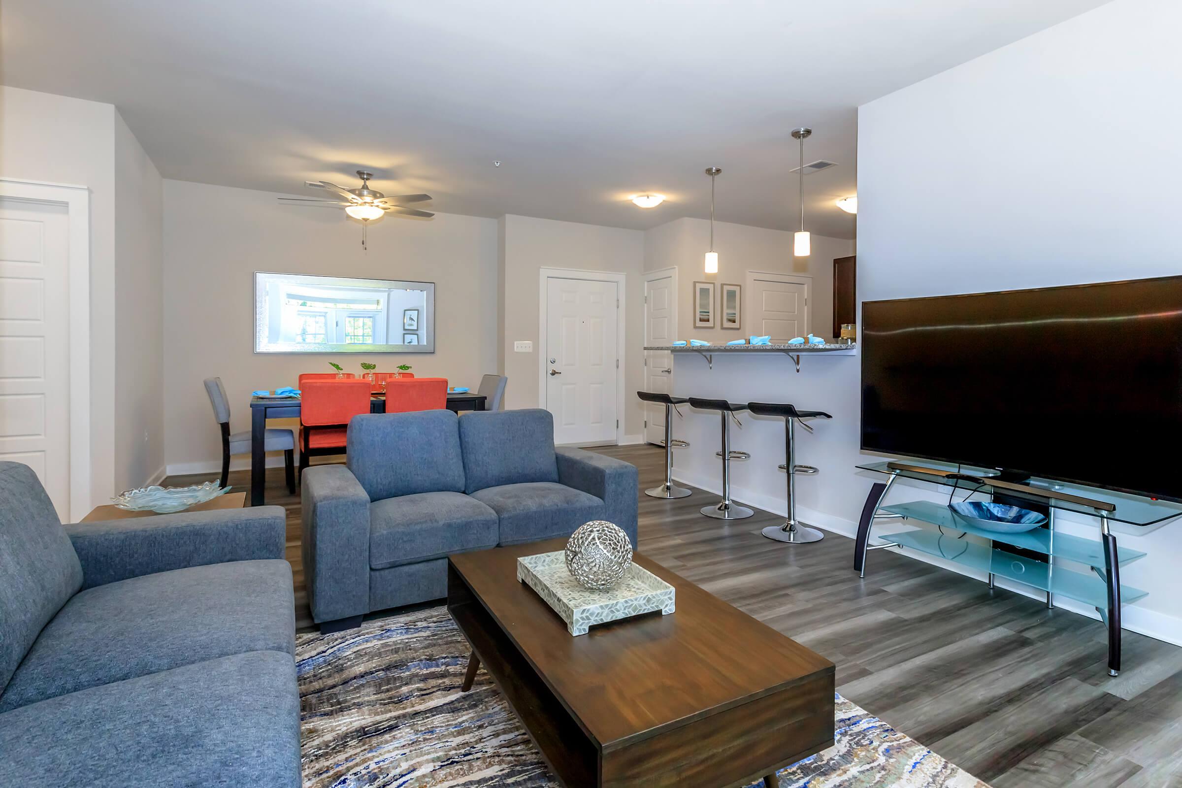 a living room filled with furniture and a flat screen tv