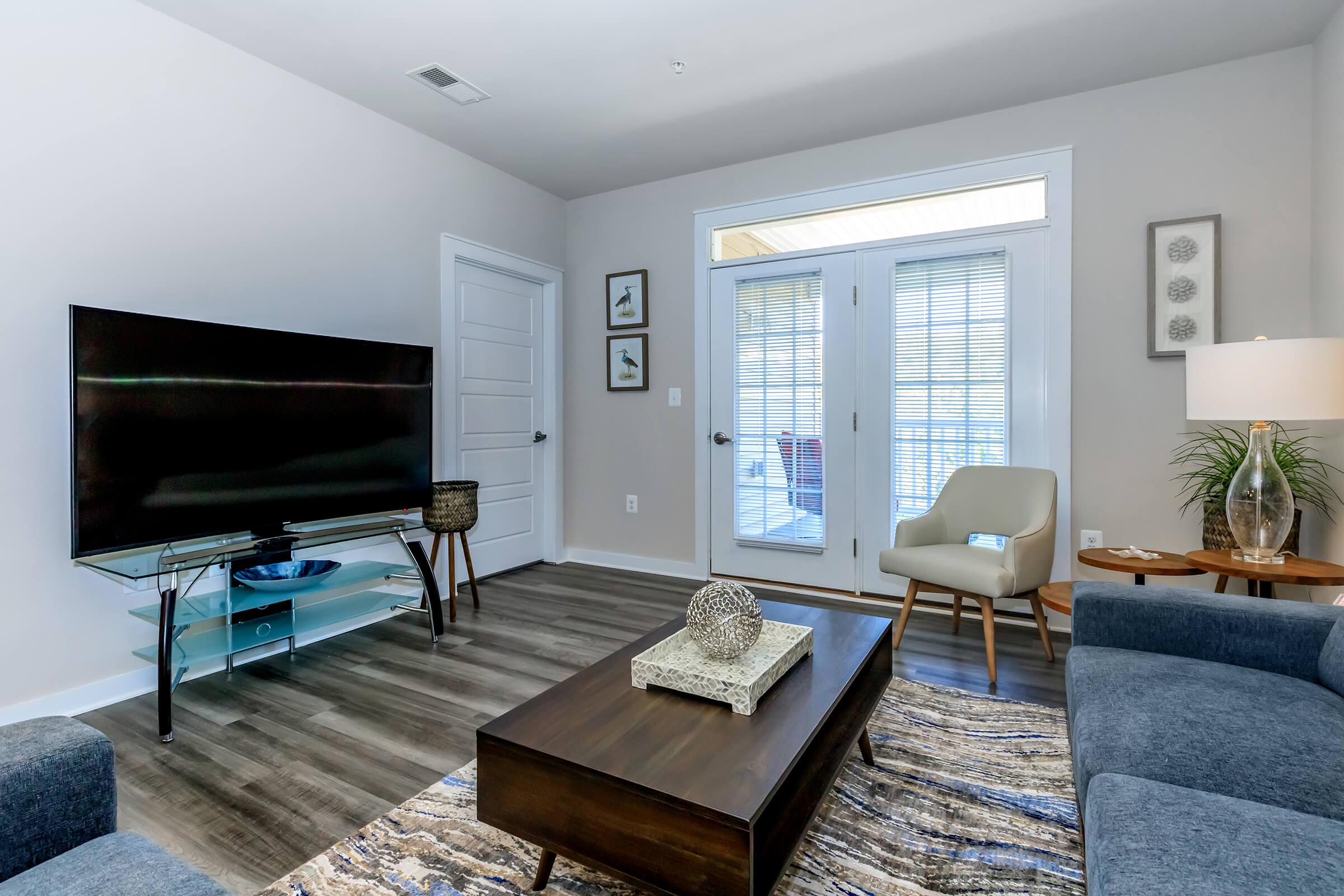 a living room filled with furniture and a flat screen tv