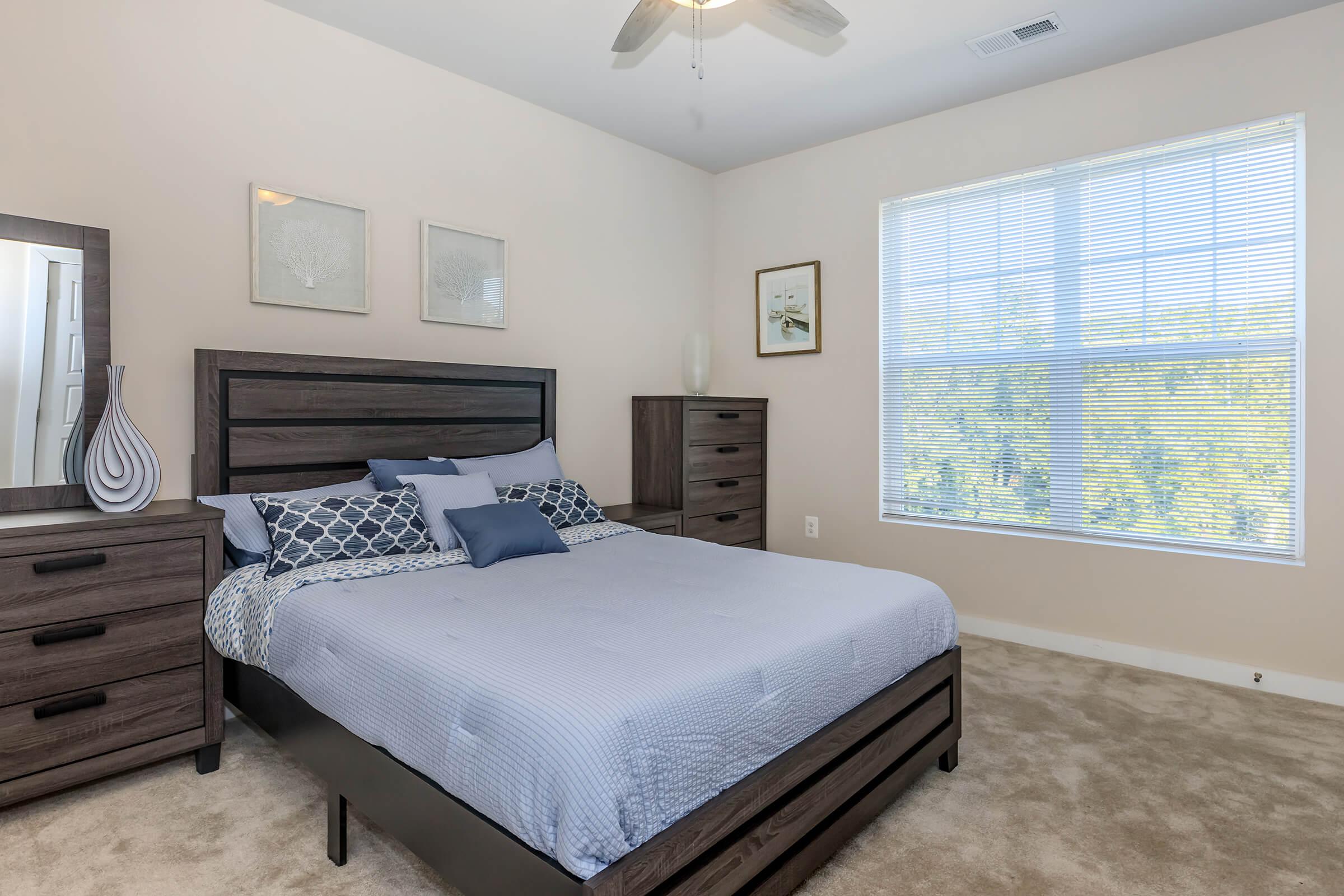 a bedroom with a bed and desk in a room