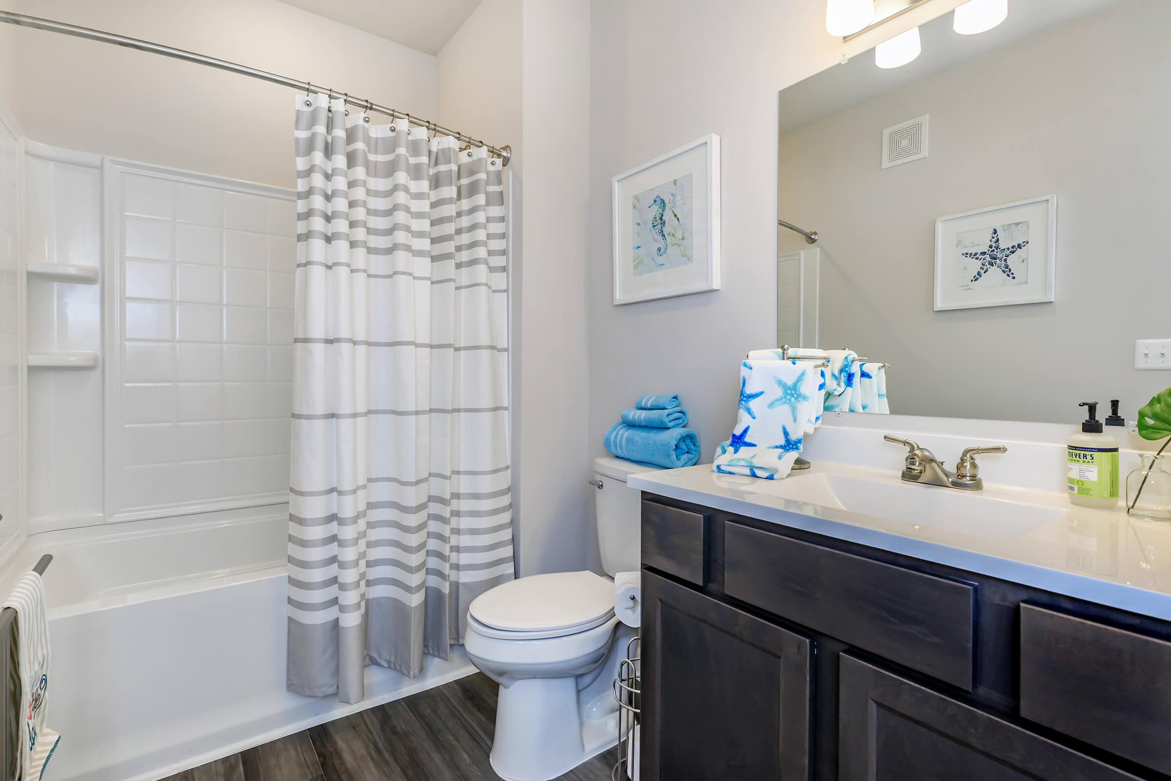 a large white tub next to a sink