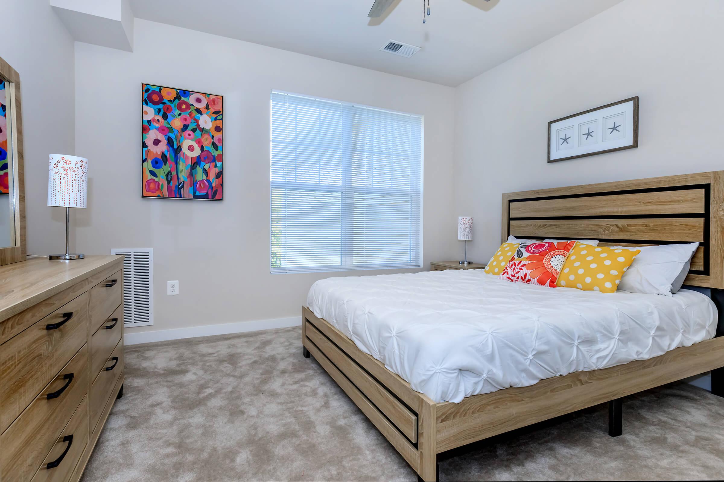 a bedroom with a bed and desk in a room