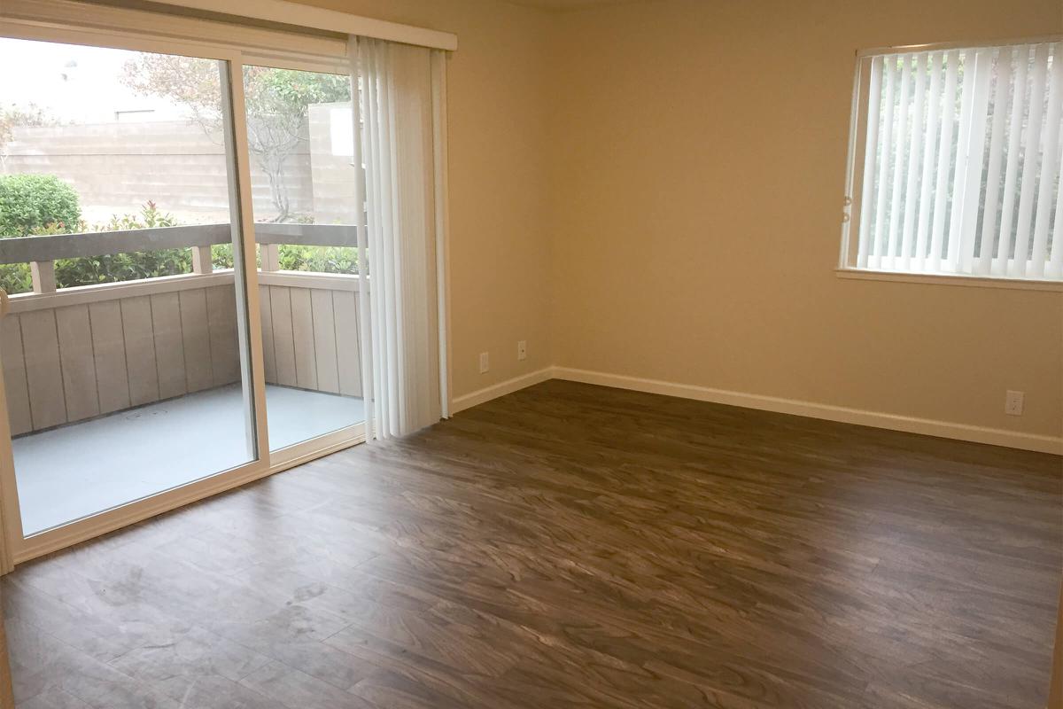 a room with wood floor and a window